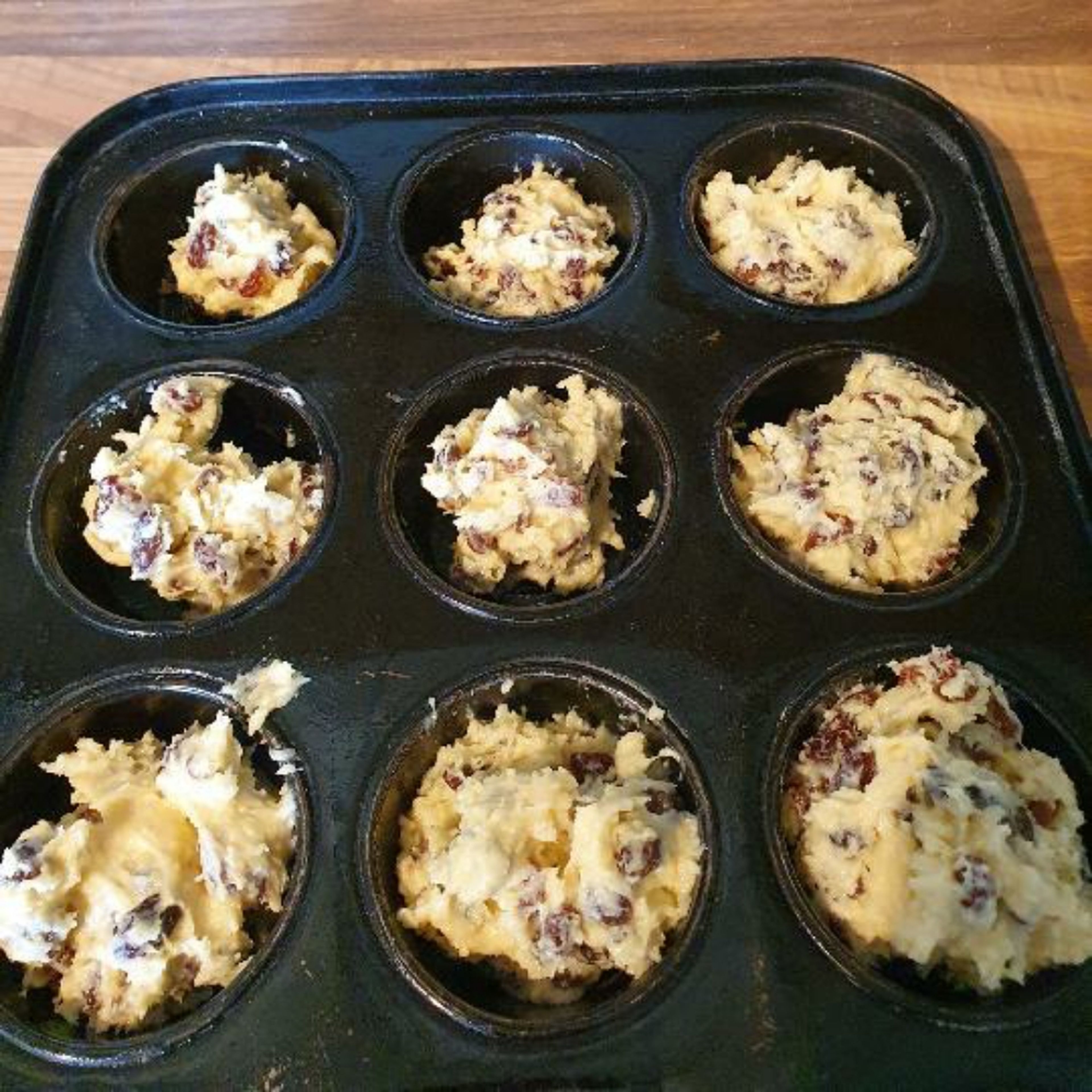 Grease a muffin tin with a non stick cooking tray or with butter. Place pieces of of dough in the muffin tray. Make sure to ore hear the oven 180°C/350°F gas mark 4. bake for 15-25 minutes.
