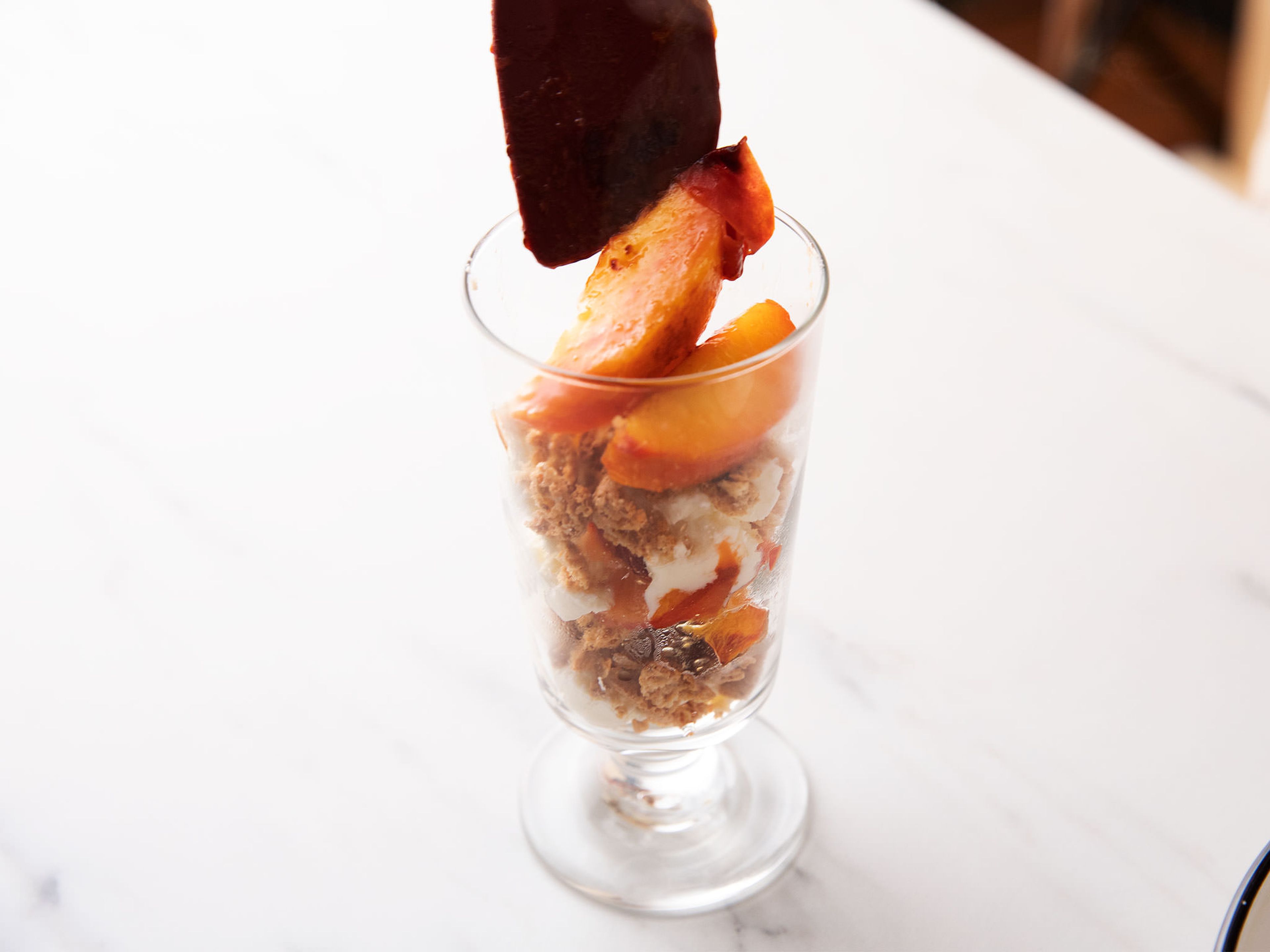 Put a few nectarine slices in the bottom of a trifle glass. Add a layer of mascarpone. Sprinkle with some amaretti pieces. Layer until the top of the glass is reached, then garnish with remaining nectarine slices and a finishing sprinkle of amaretti. Enjoy!