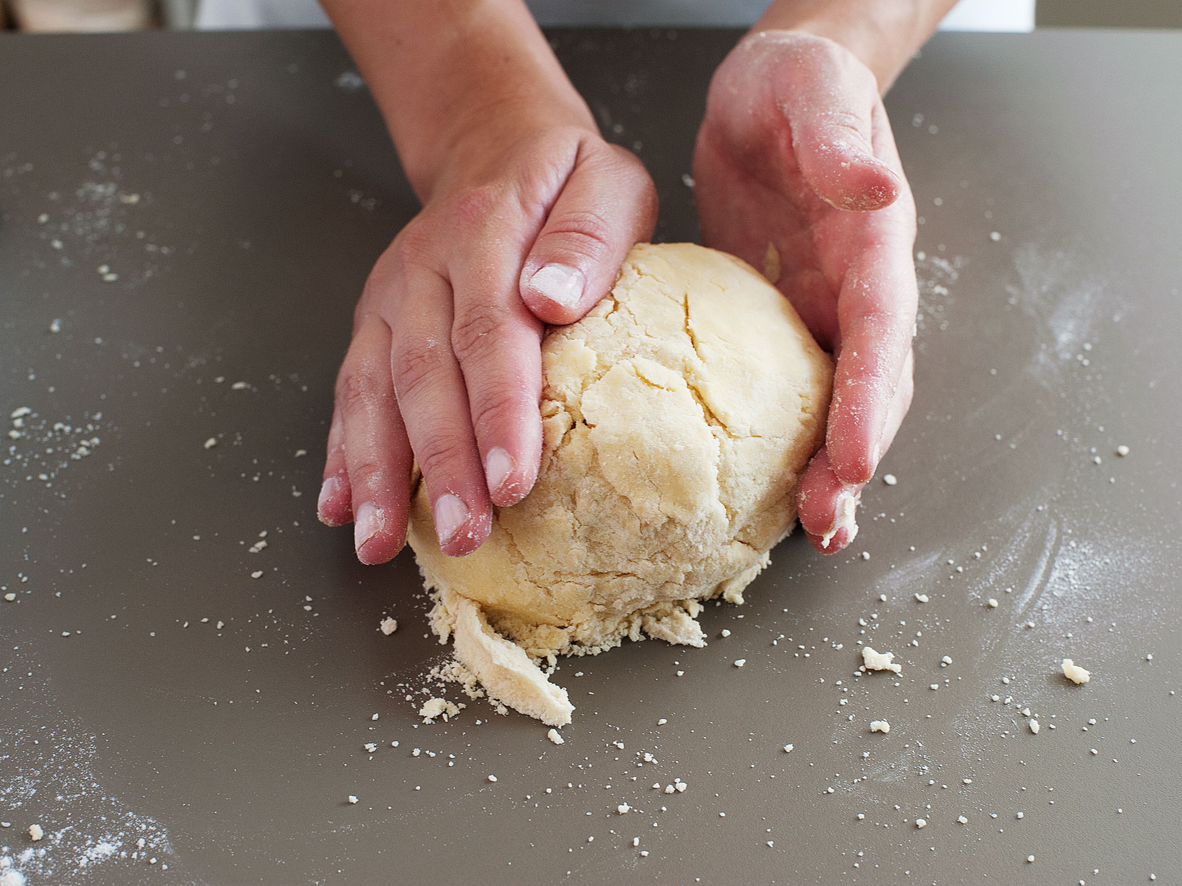 Scrape dough onto a lightly floured work surface and press the dough into a compact disc, then halve and form each half into a disc. Wrap in plastic wrap and refrigerate for an hour.