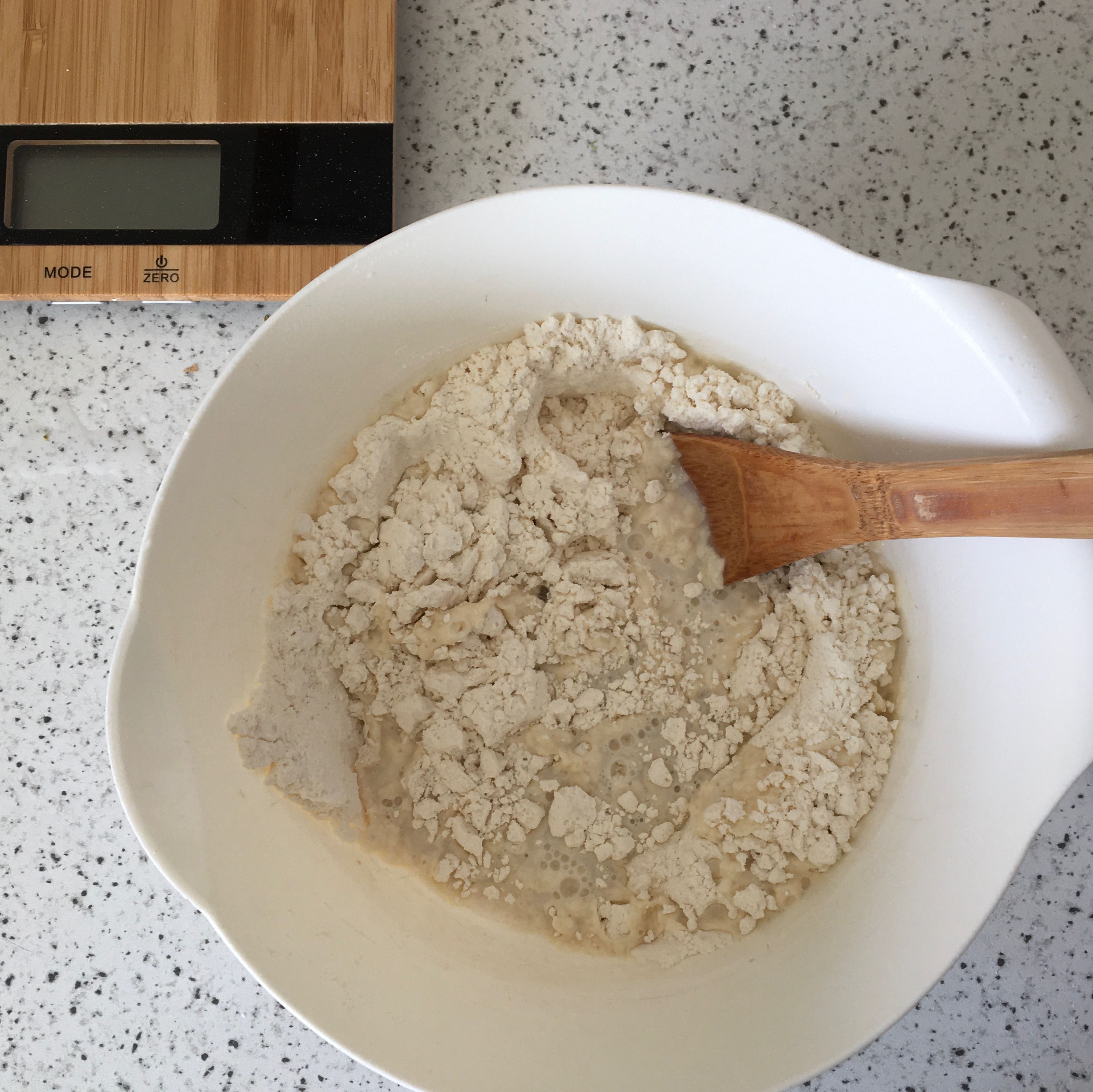 Measure the flour into a bowl. Add the yeast, salt and sugar. Pour in the water and mix with a wooden spoon until a sticky dough starts to come together.