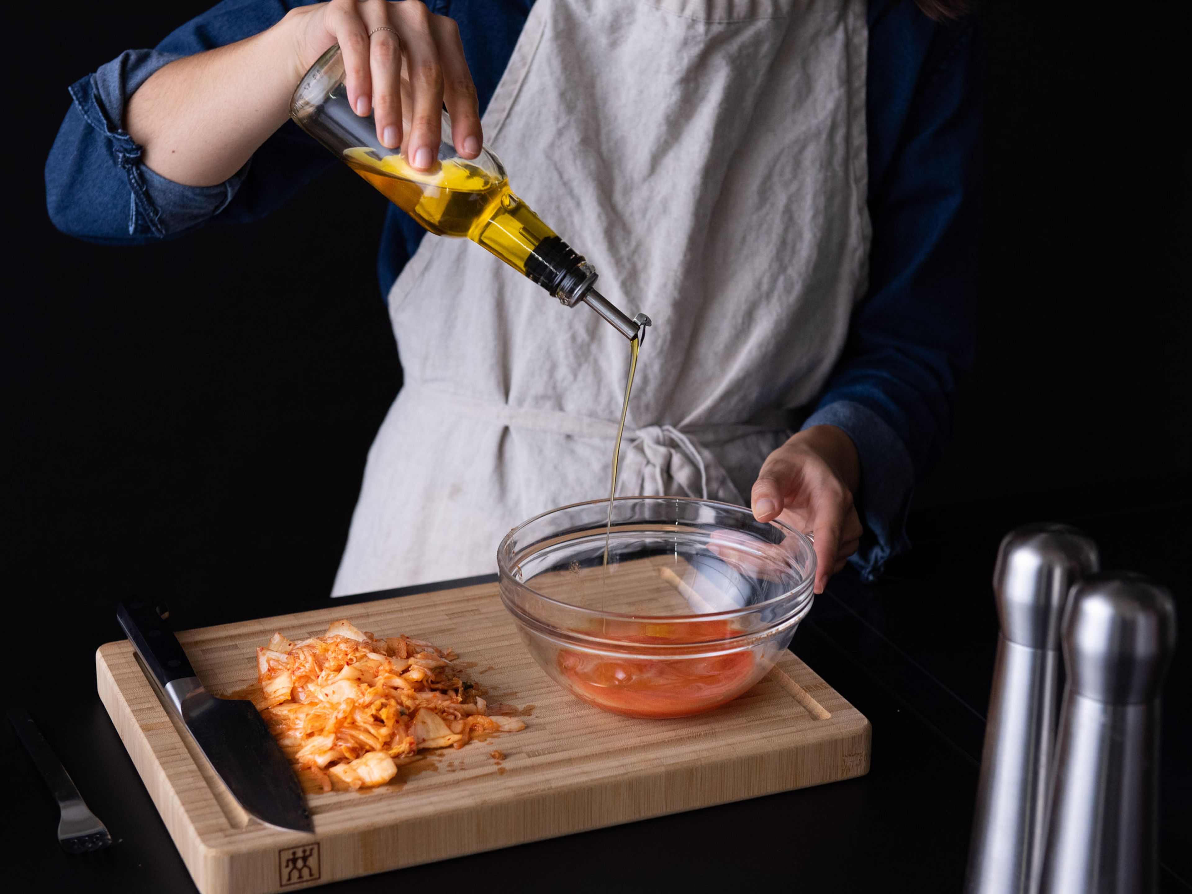 Set the kimchi in a fine sieve over a bowl and press to remove excess liquid, then roughly chop. Whisk the kimchi juice with rice vinegar and olive oil to make the salad dressing. Season to taste with salt and pepper and set aside.