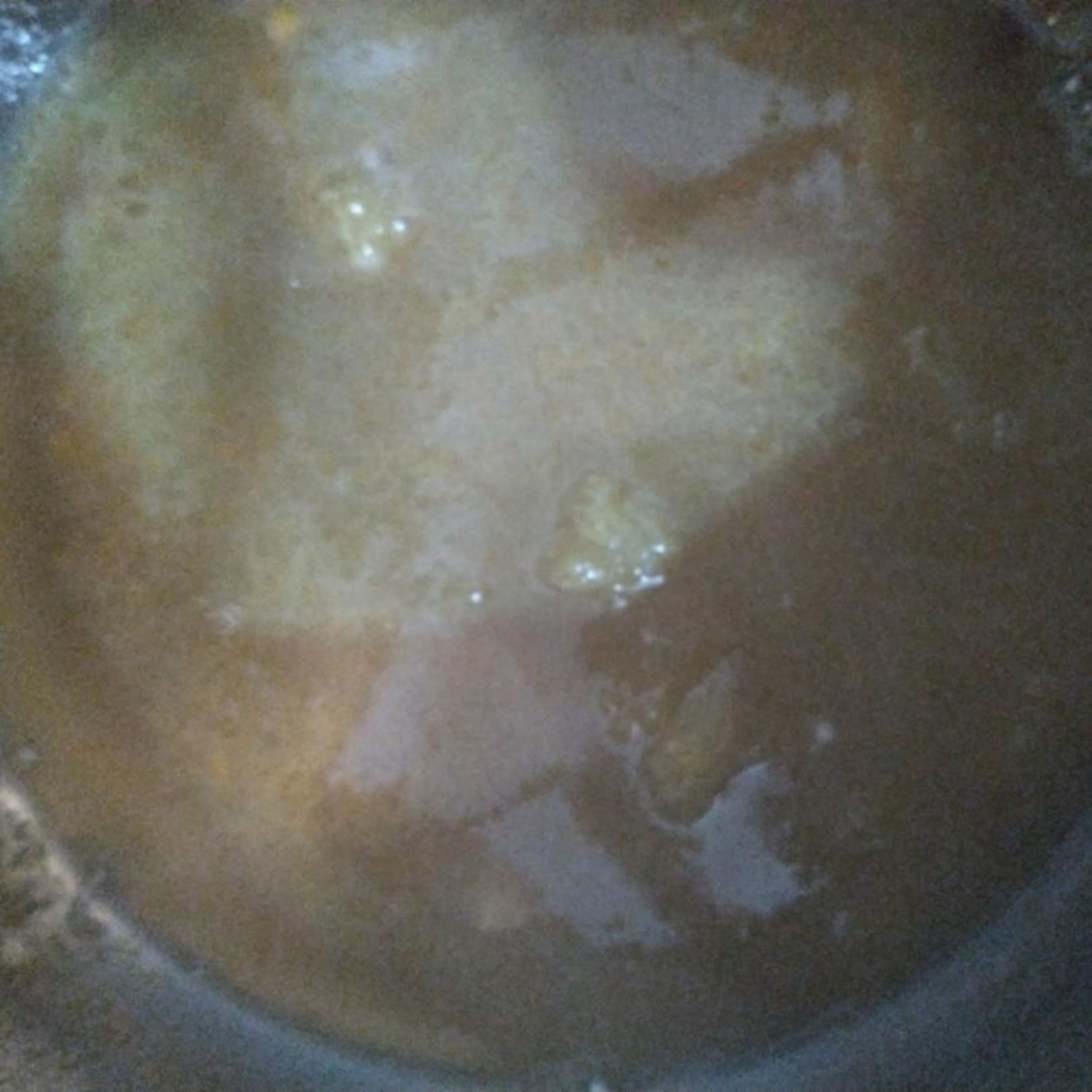 Bring the honey, sugar, water and yeast extract to a simmer in a saucepan. Add the orange juice and zest, and ground cardamom seeds and a cinnamon stick, if you like. Simmer until slightly reduced, about 3-4 minutes.