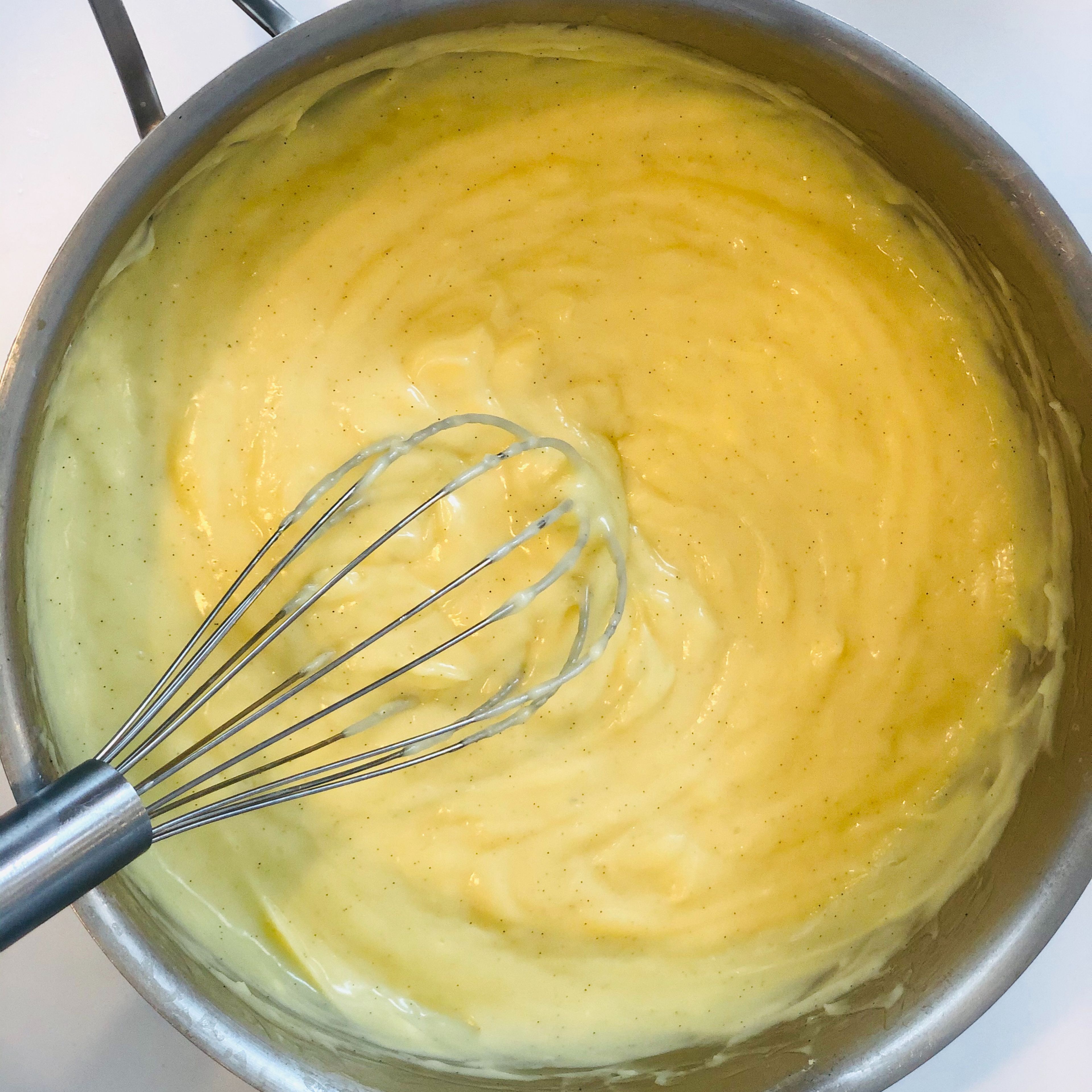 For the pastry cream, heat the milk in a medium sized saucepan over medium heat. Meanwhile whisk the egg yolks, sugar, salt, and cornstarch in a bowl. Pour about a cup of the heated milk inti the egg mixture to temper them, then return the entire thing to medium low heat. Whisk until a thick cream is formed, then turn off the heat. Add butter and vanilla and chill, covered tightly until use.