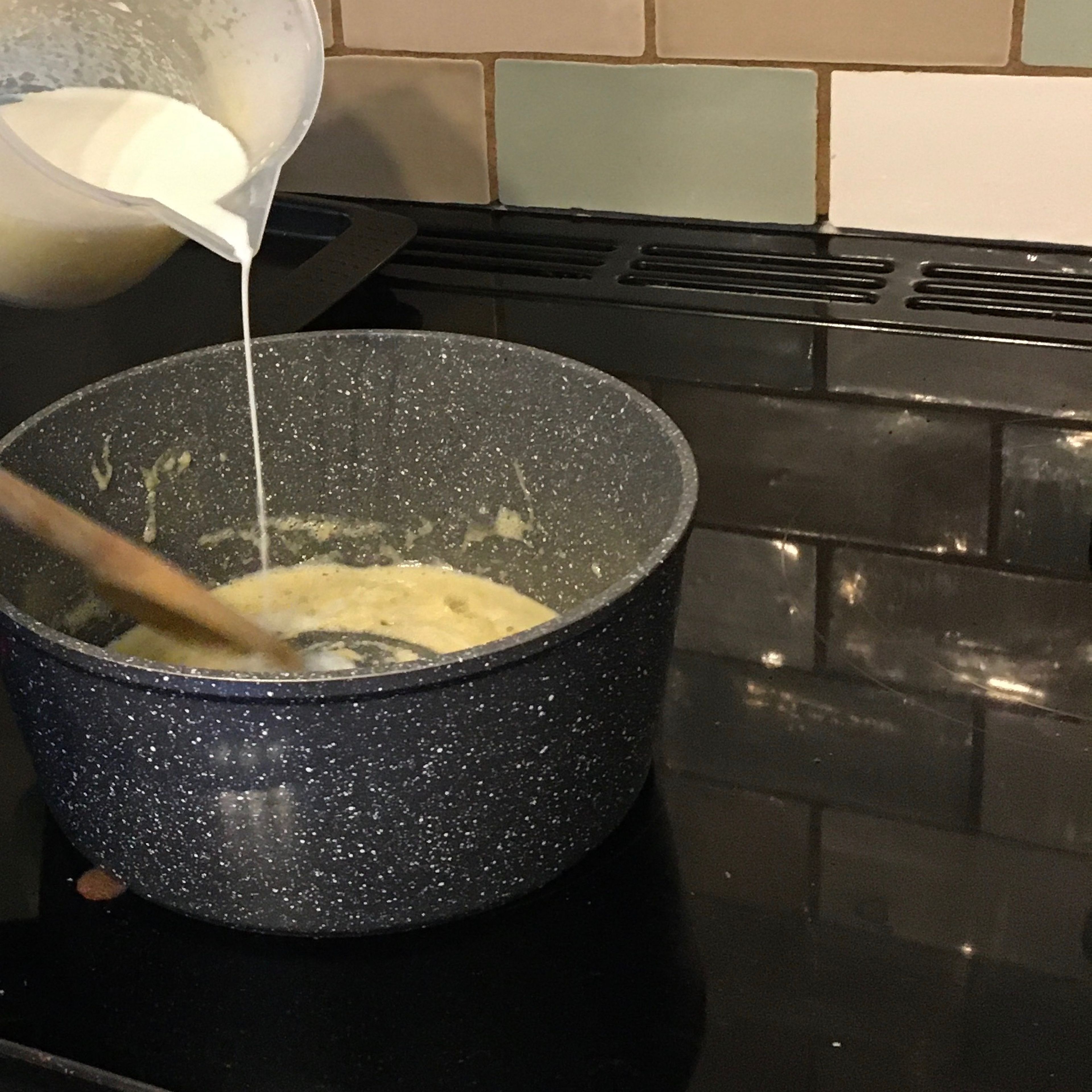Slowly add the milk to the melted butter and flour stirring continuously until smooth.