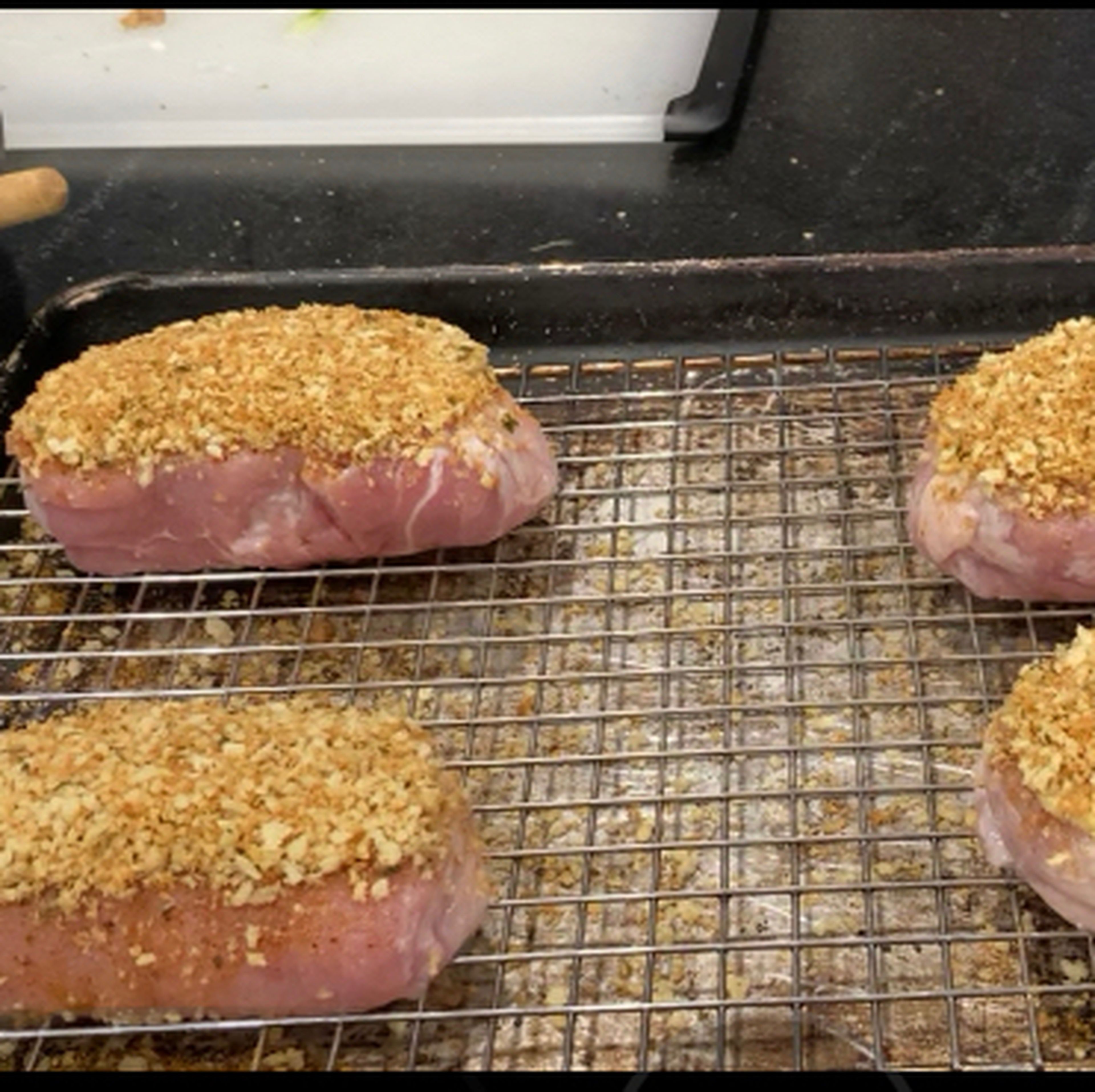Next put the bread crumbs on each pork chop, again patting it gently to somewhat pack the bread crumbs. Then bake at 250 Degrees ￼Fahrenheit￼ for an hour or until the internal temperature is 150 Degrees￼Fahrenheit