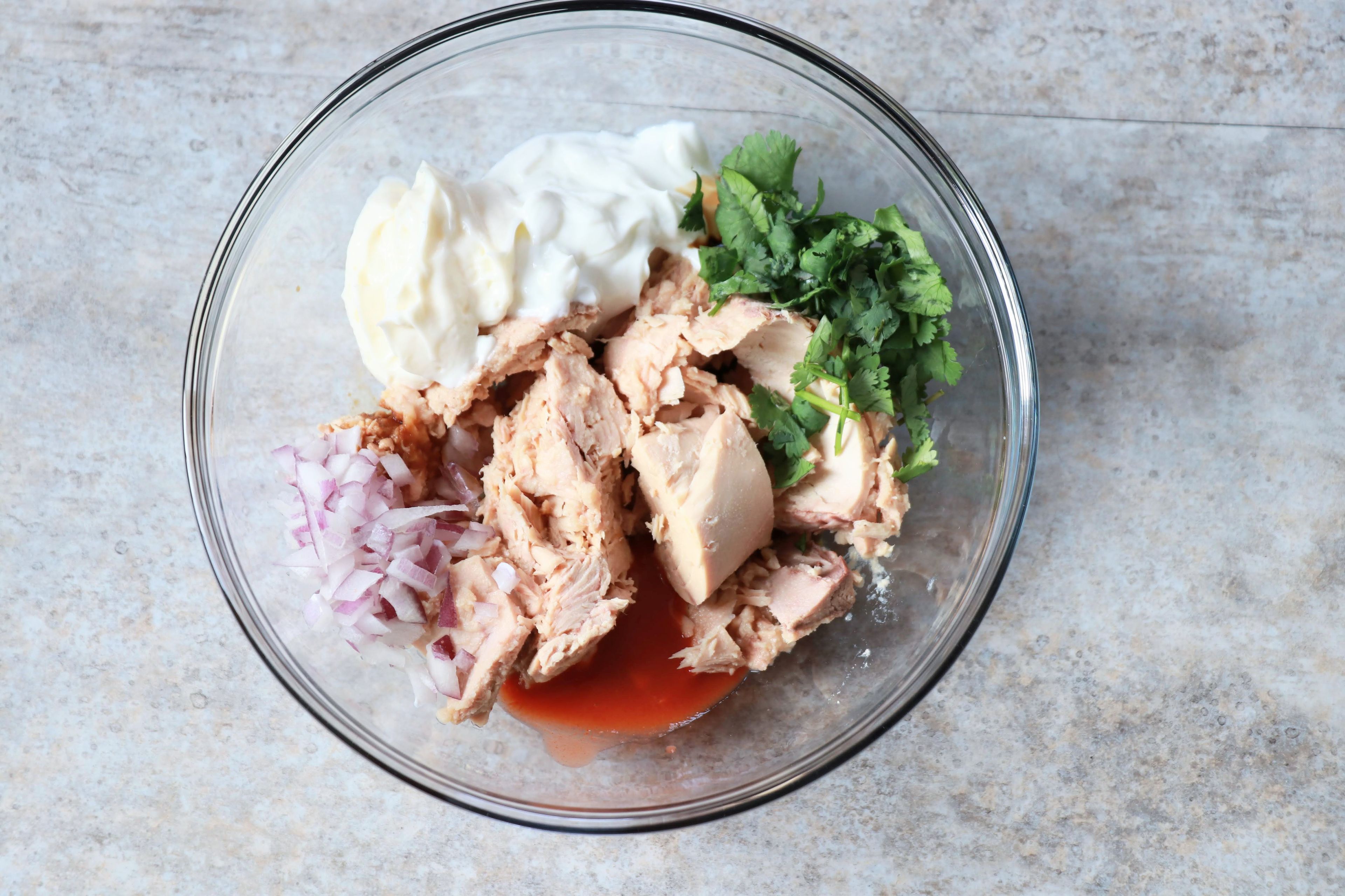 Combine sriracha, soy sauce, lime juice, cilantro, yogurt, and mayonnaise with tuna.