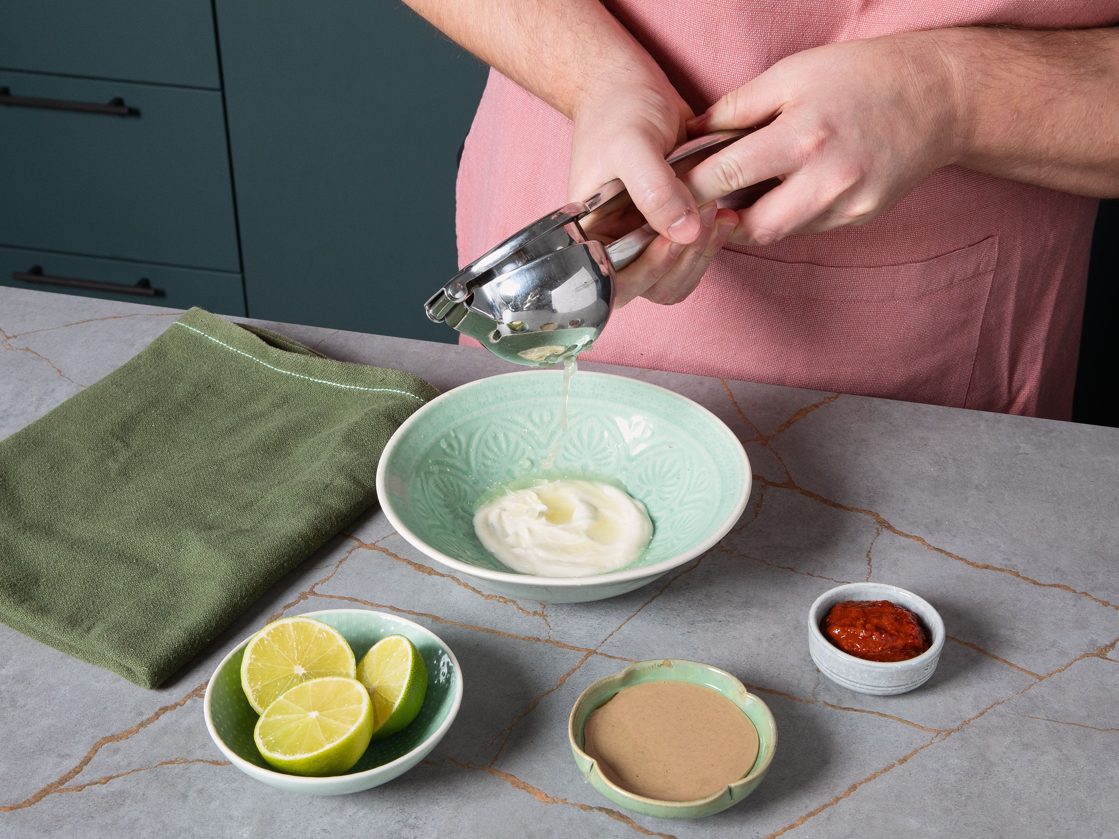 Meanwhile, prepare the dressing: In a small bowl, mix harissa, tahini, mayonnaise, agave syrup, lime juice, and a little oil from the sun-dried tomatoes into a smooth sauce. Finely chop the cornichons, sun-dried tomatoes, red onion, and chives.