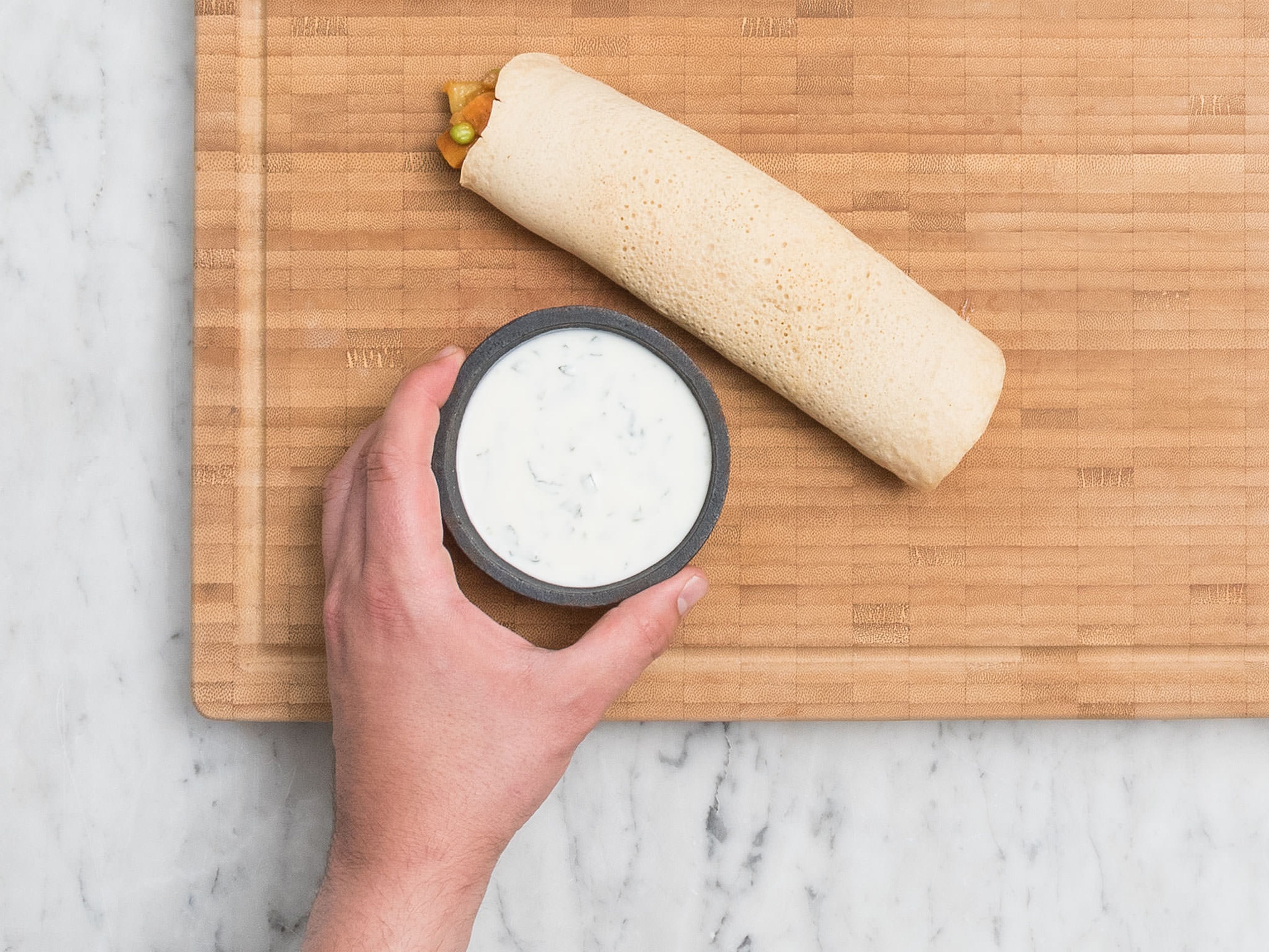 Fill dosa with potato filling and carefully roll up. Serve with the mint-yogurt sauce. Enjoy!