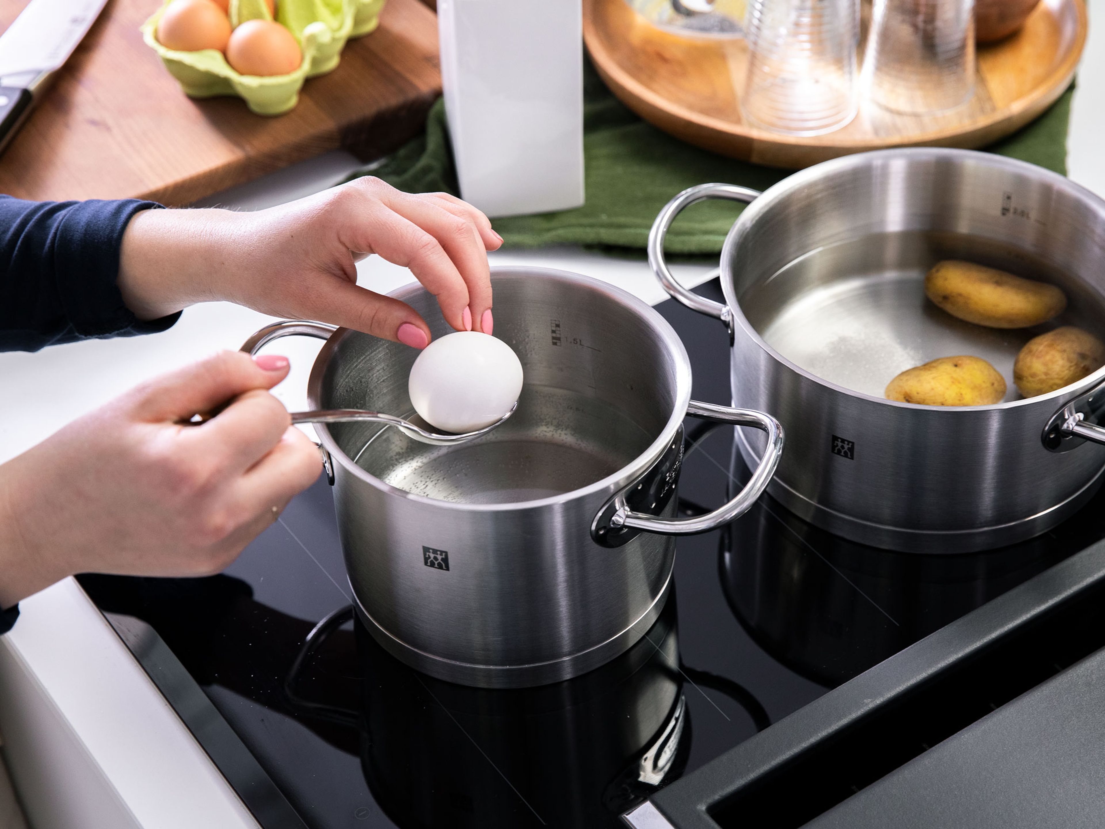 Add potatoes to a pot with cold water. Season with salt, bring to a boil, and boil until tender. In the meantime, boil eggs in a separate pot of water for approx. 6 – 7 min. Drain potatoes and eggs and let cool. Peel and chop into bite-sized pieces.