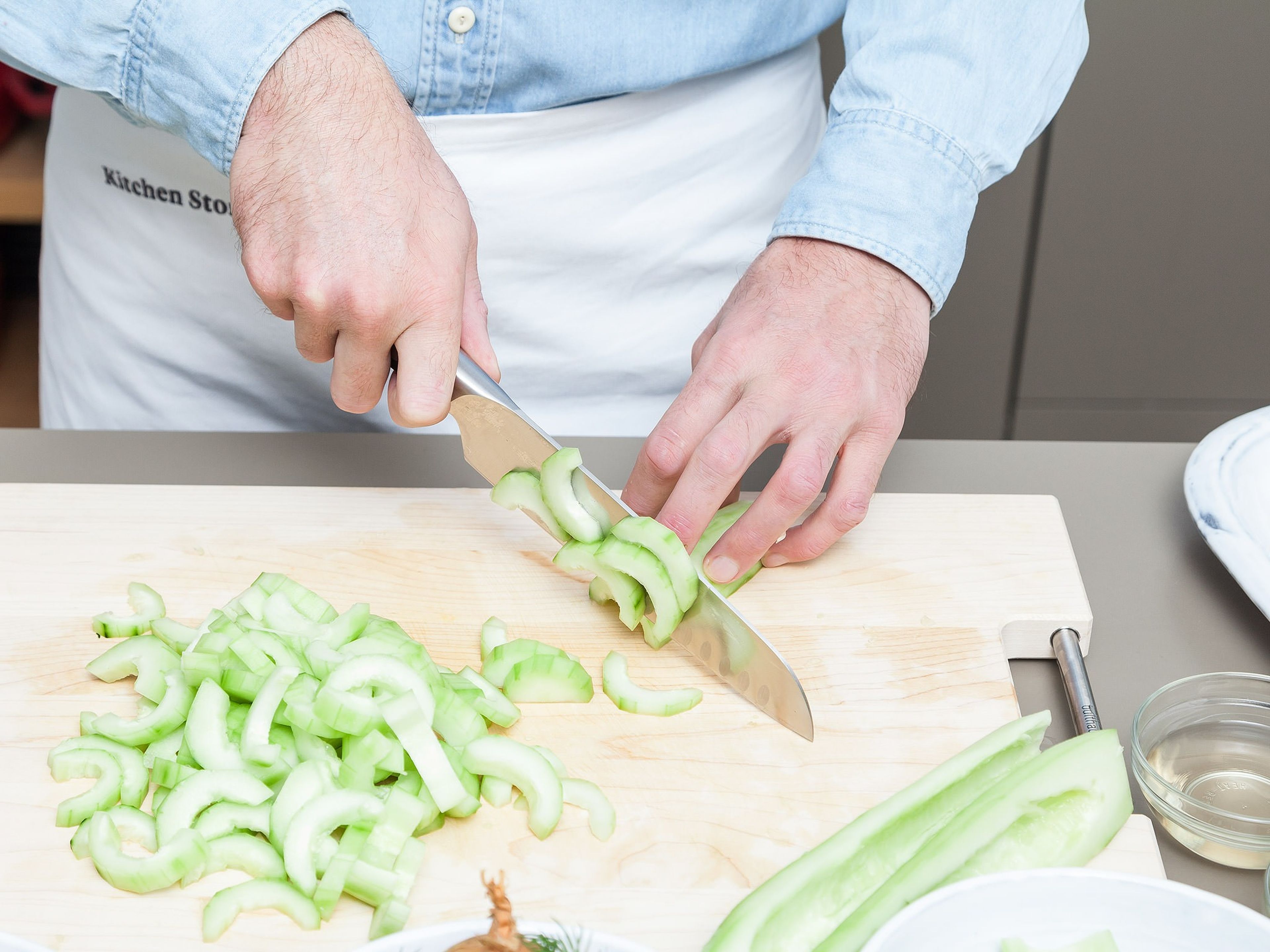 Peel cucumbers. Halve lengthwise, remove seeds with a spoon, and cut into 2 cm/0.8 in.- thick slices. Peel and finely dice potatoes. Chop dill. Peel onion and cut into thin slices.