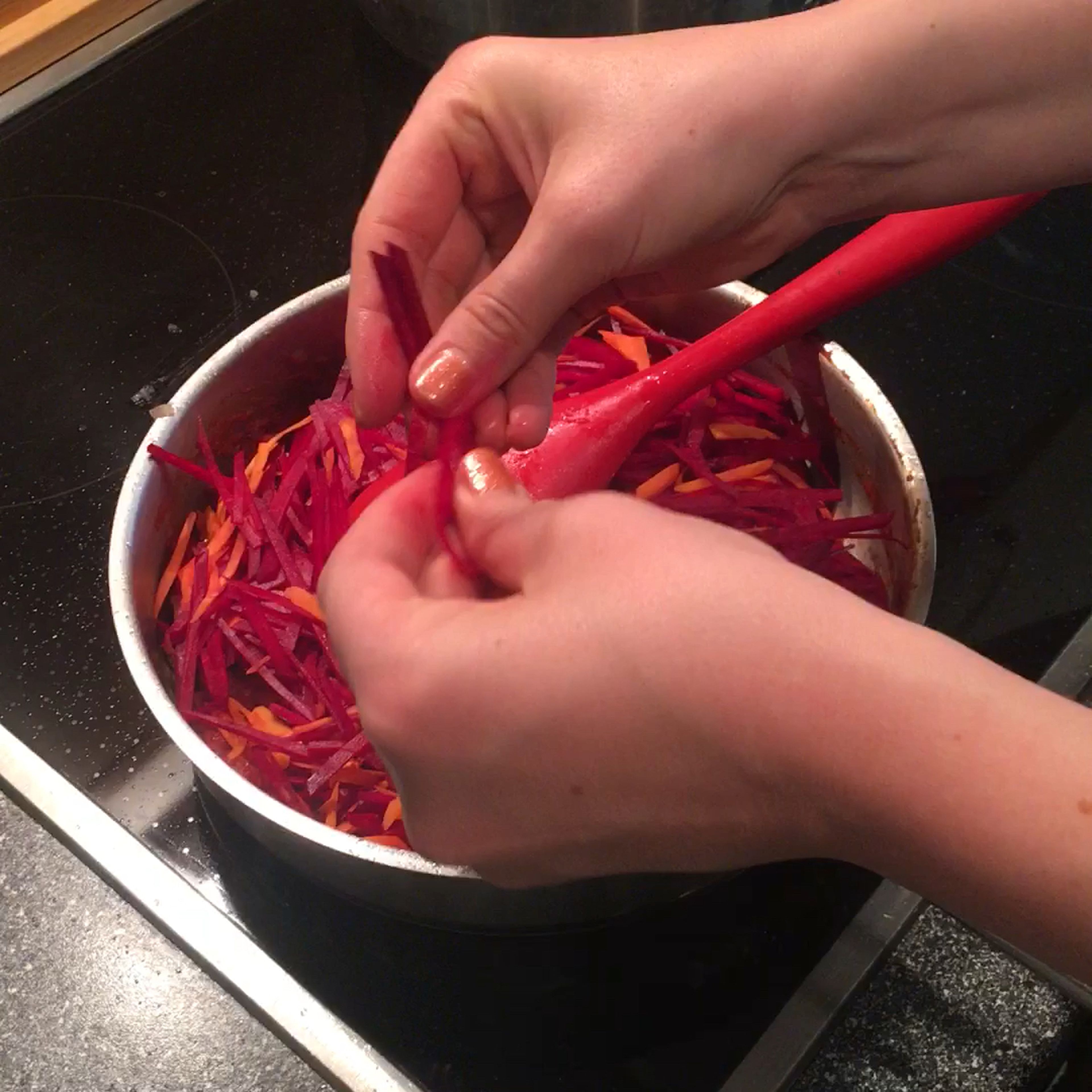 Mixing shallots, beets, carrots and tomato paste together with 2 tbsp of salt. If too dry, add water from the boiling water