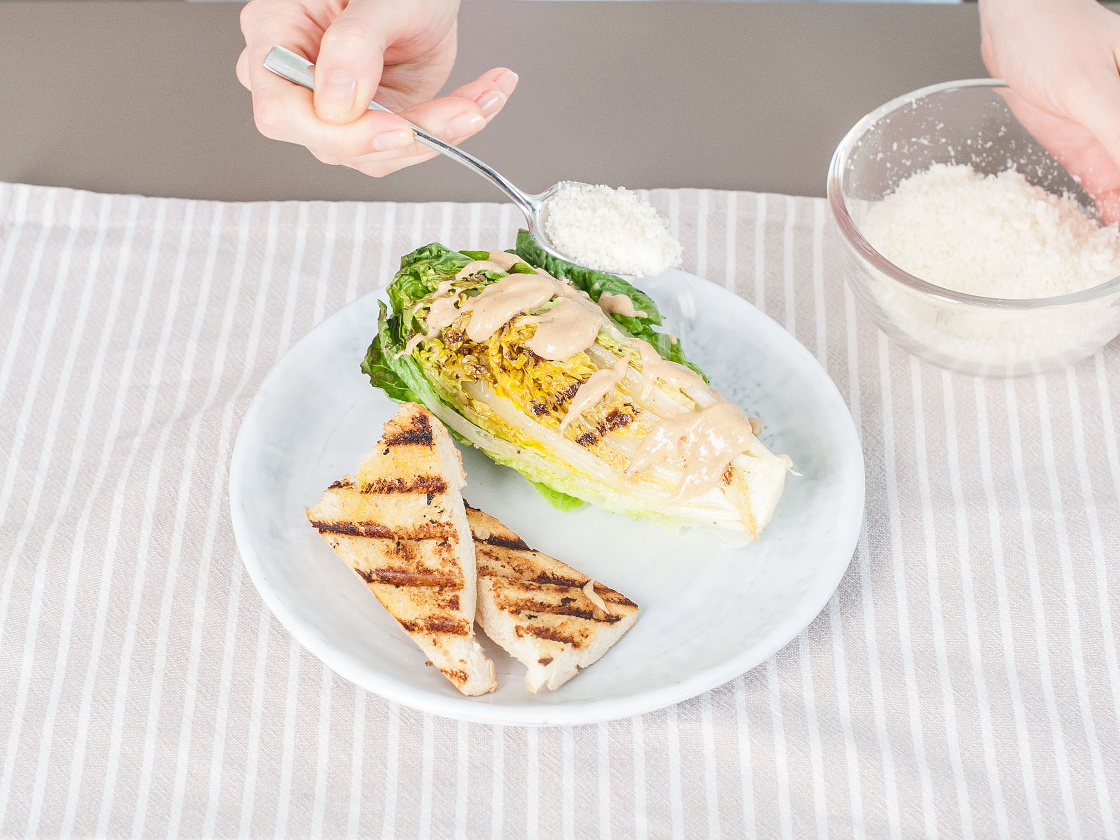 Serve romaine hearts and bread whole or cut into wide strips. Drizzle or toss with Caesar dressing to taste and top with remaining grated Parmesan cheese.