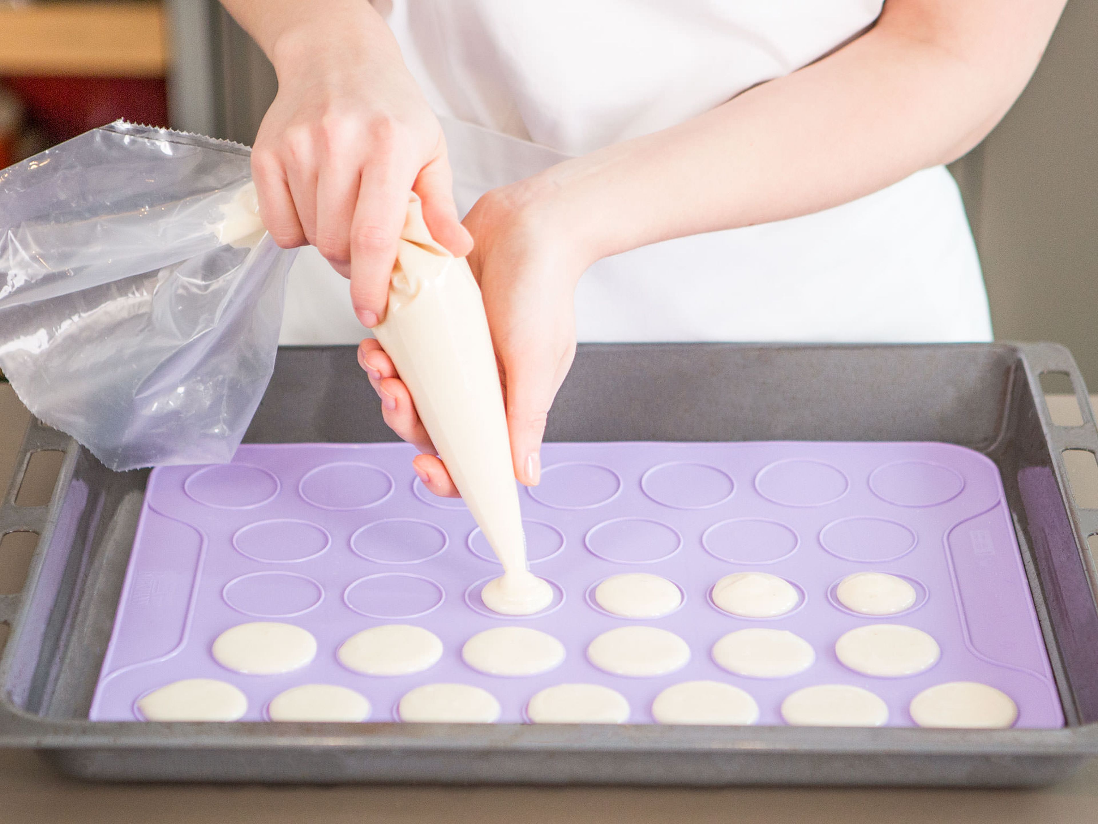 Fill a piping bag with macaron mixture. Pipe onto a baking sheet lined with a macaron baking mat. Tap hard onto kitchen counter to release any air bubbles. Let stand at room temperature for approx. 30 – 40 min. Then, bake in preheated oven at 140°C/285°F for approx. 12 – 15 min.