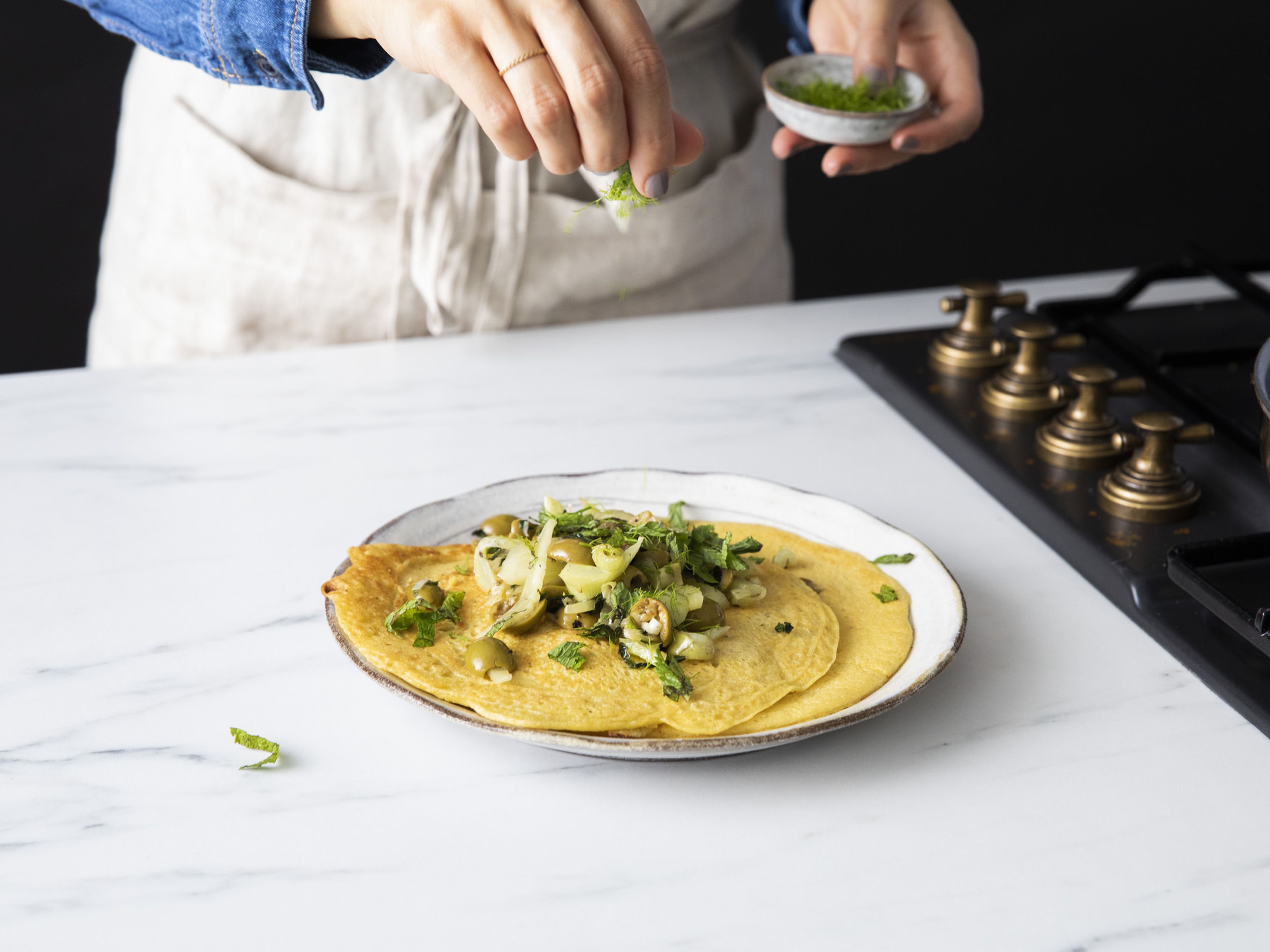 Top each pancake with half the fennel and olive mixture, mint, and any fennel fronds. Enjoy!