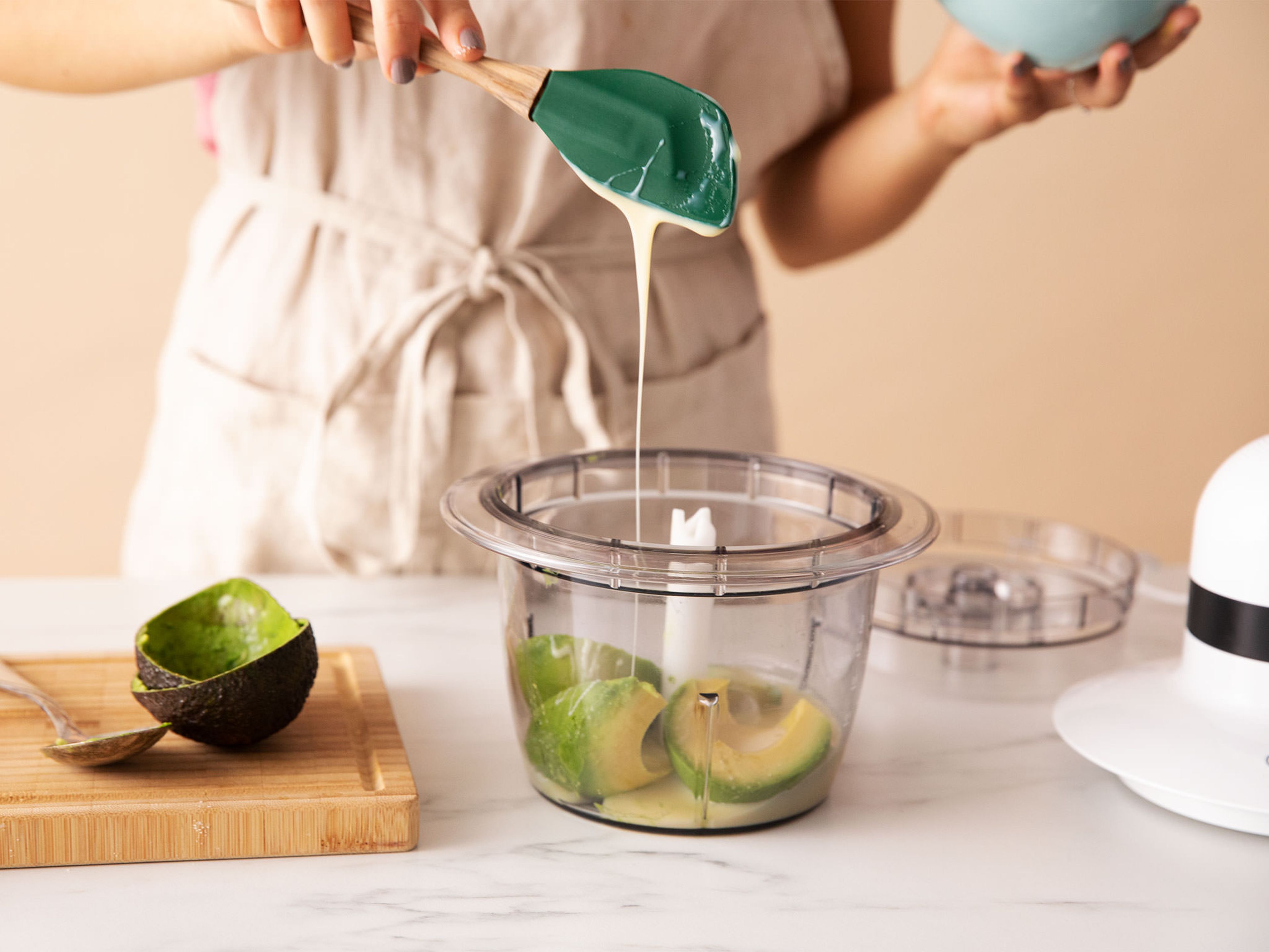Blend avocado and sweetened condensed milk in a food processor with a pinch of salt. Whip heavy cream to stiff peaks in a cold bowl using a hand mixer.