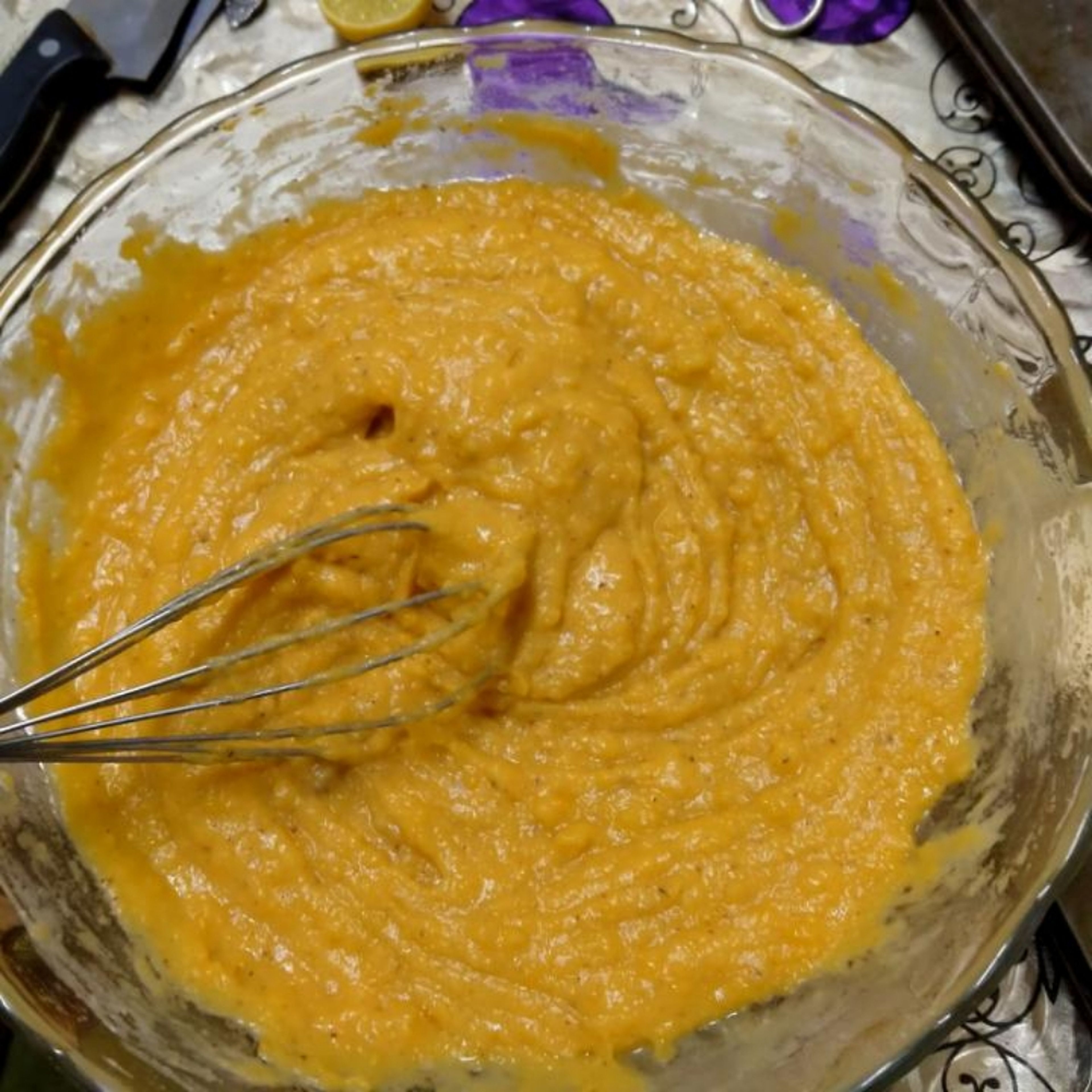 with a hand whisk or electric mixer mix and mash the sweet potato until well mashed and smooth then add the sugar and milk and mix to incorporate well add the eggs one by one. add the flour, lemon and all the spices and vanilla and mix mix mix . at the end add the melted butter and mix well