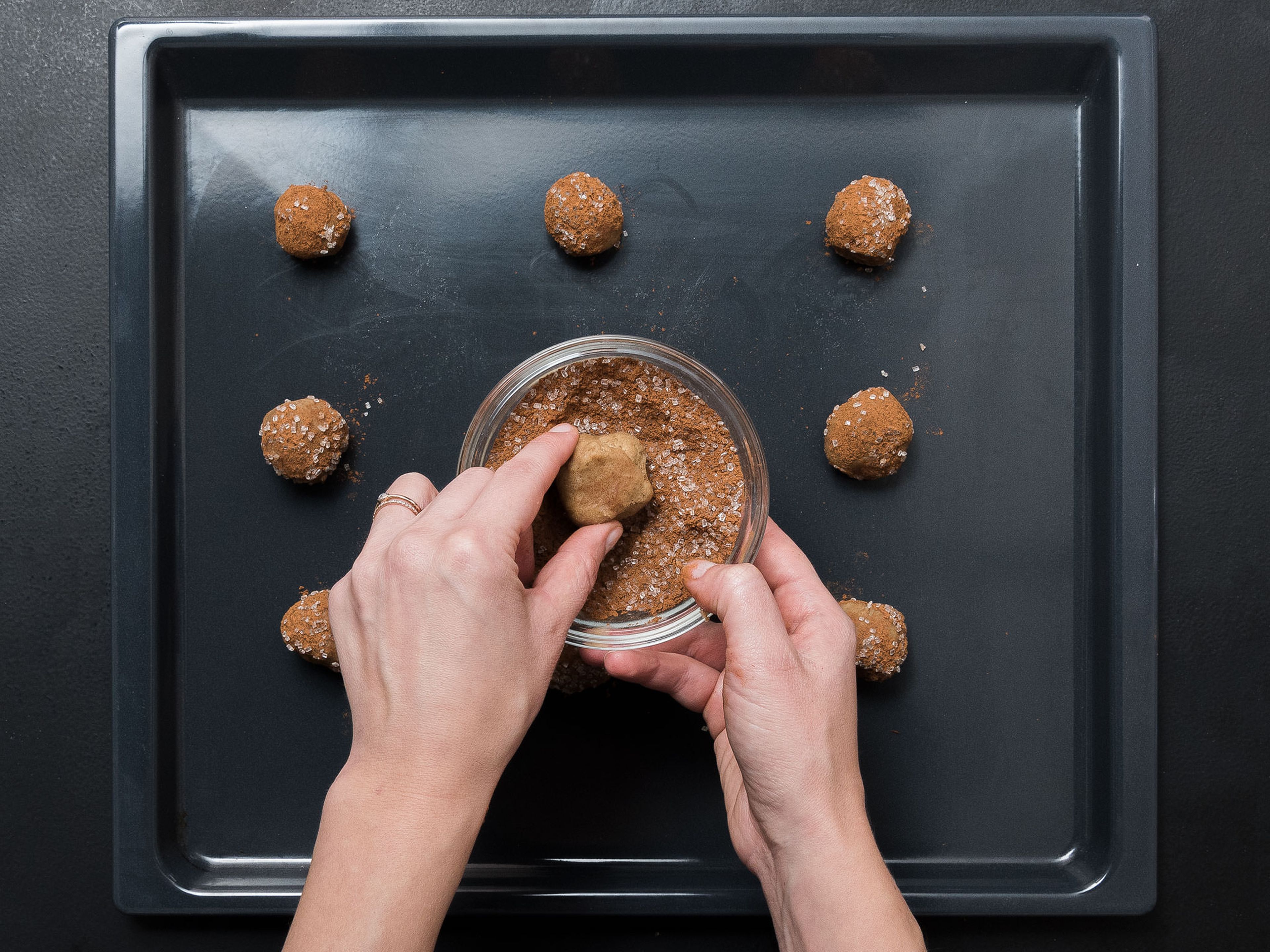 Preheat oven to 190°C/375°F and line a baking sheet with parchment paper, if needed. Using a teaspoon, scoop dough into equal-sized small balls. Roll in cinnamon sugar and transfer to baking sheet. Bake for approx. 8 – 10 min., until golden brown. Allow cookies to cool completely.