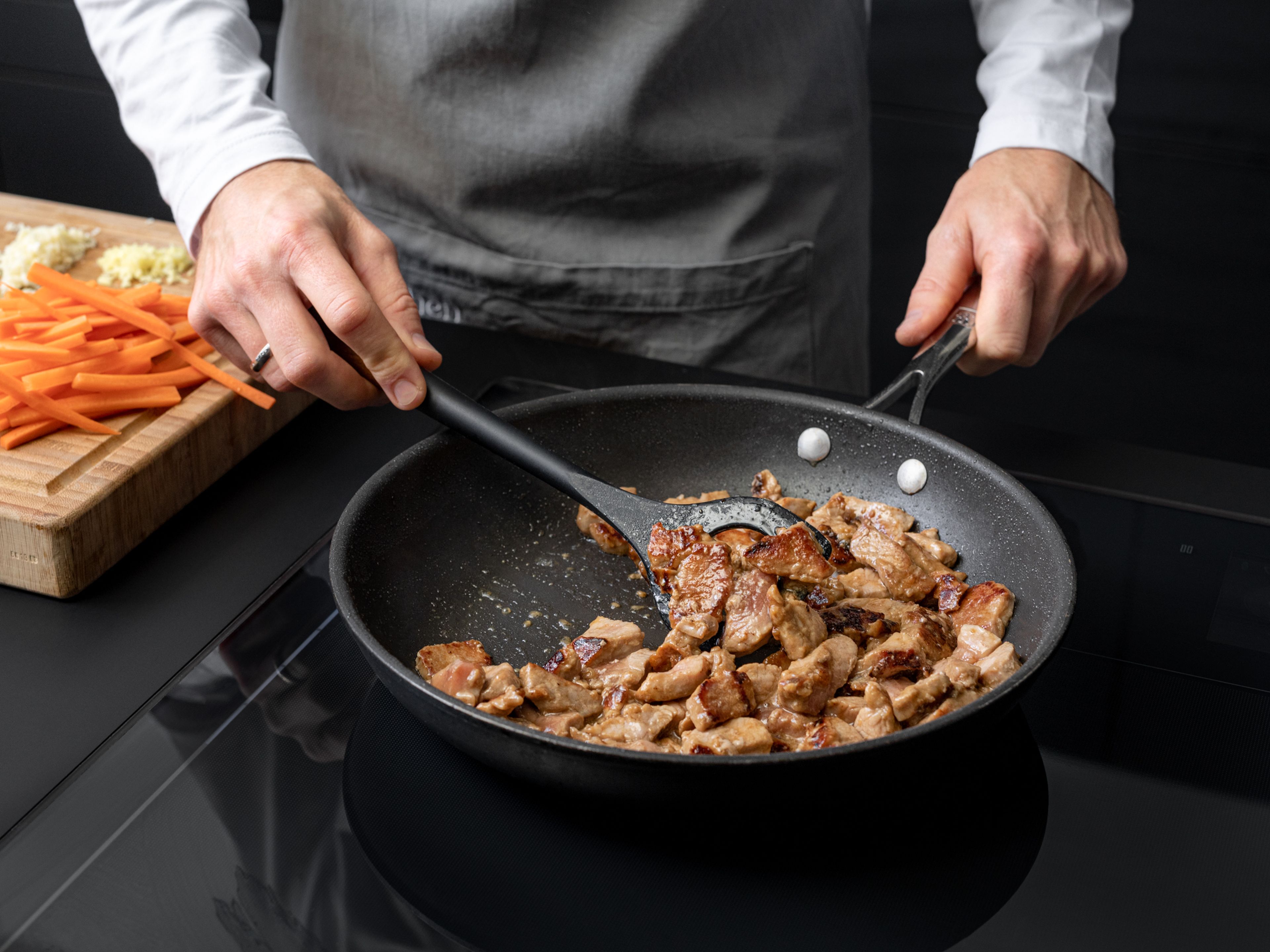 Heat vegetable oil in a non-stick frying pan over medium high heat. When oil is hot, add pork strips, and quickly stir fry to sear the meat. Leave some space in between the pork pieces to prevent sticking, if needed, fry them in two batches. When the pork is almost cooked through, remove from the pan and set aside.