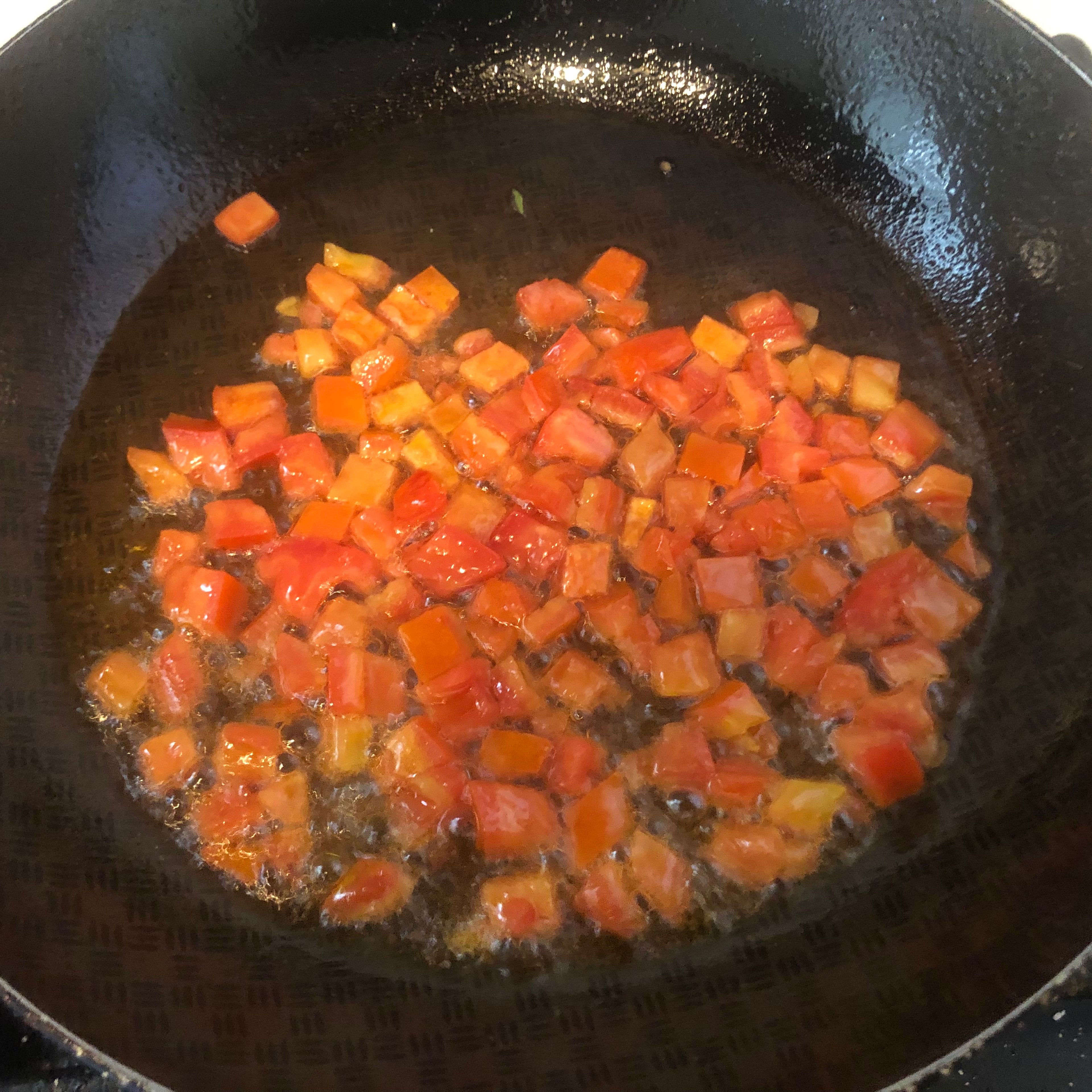 Heat the oil and sauté the tomato and the red bell pepper