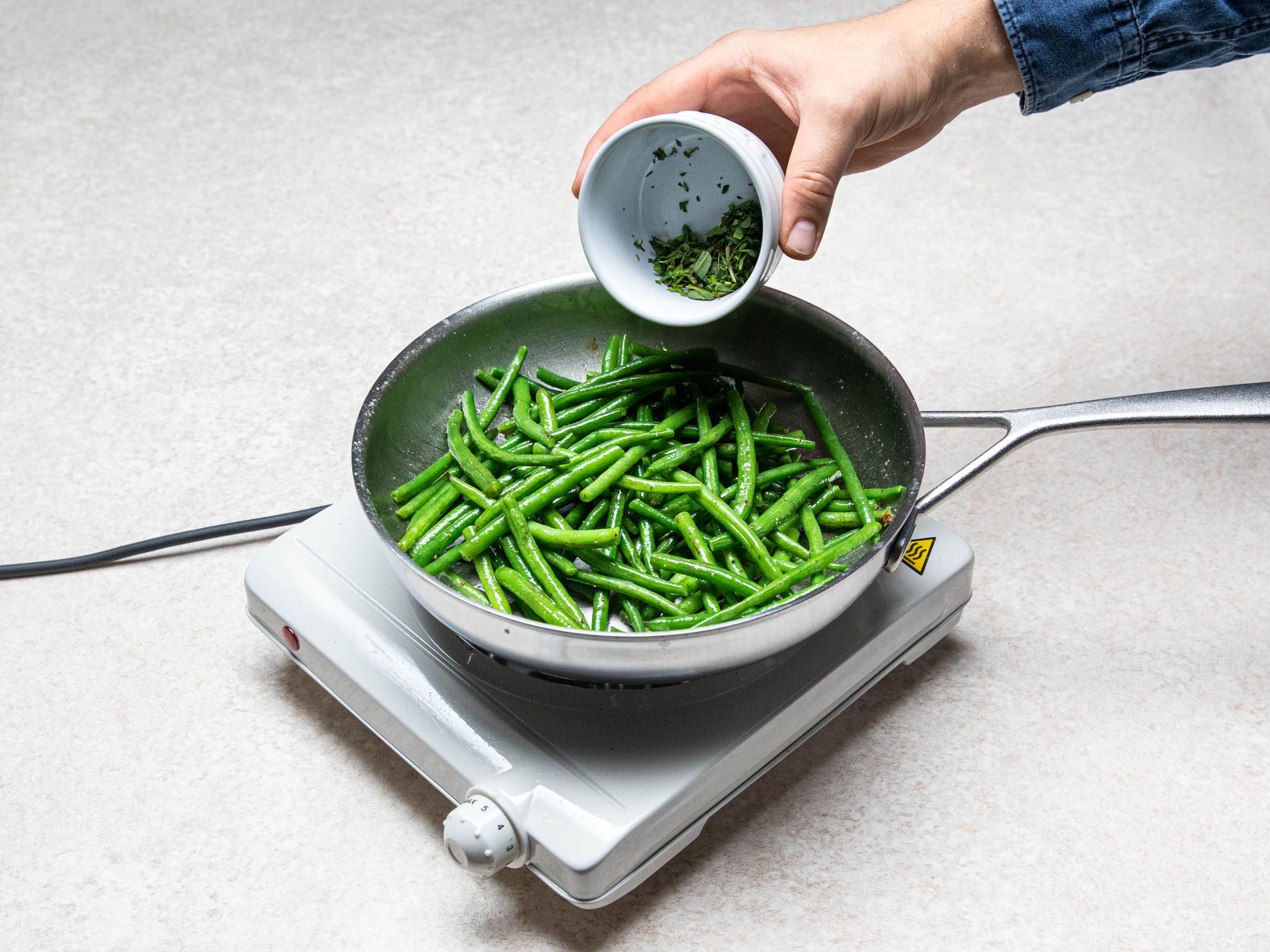 Fry blanched green beans in a frying pan with some butter. Season with salt and pepper to taste, then toss with summer savory. Serve meatballs with broth, boiled potatoes, and green beans. Enjoy!