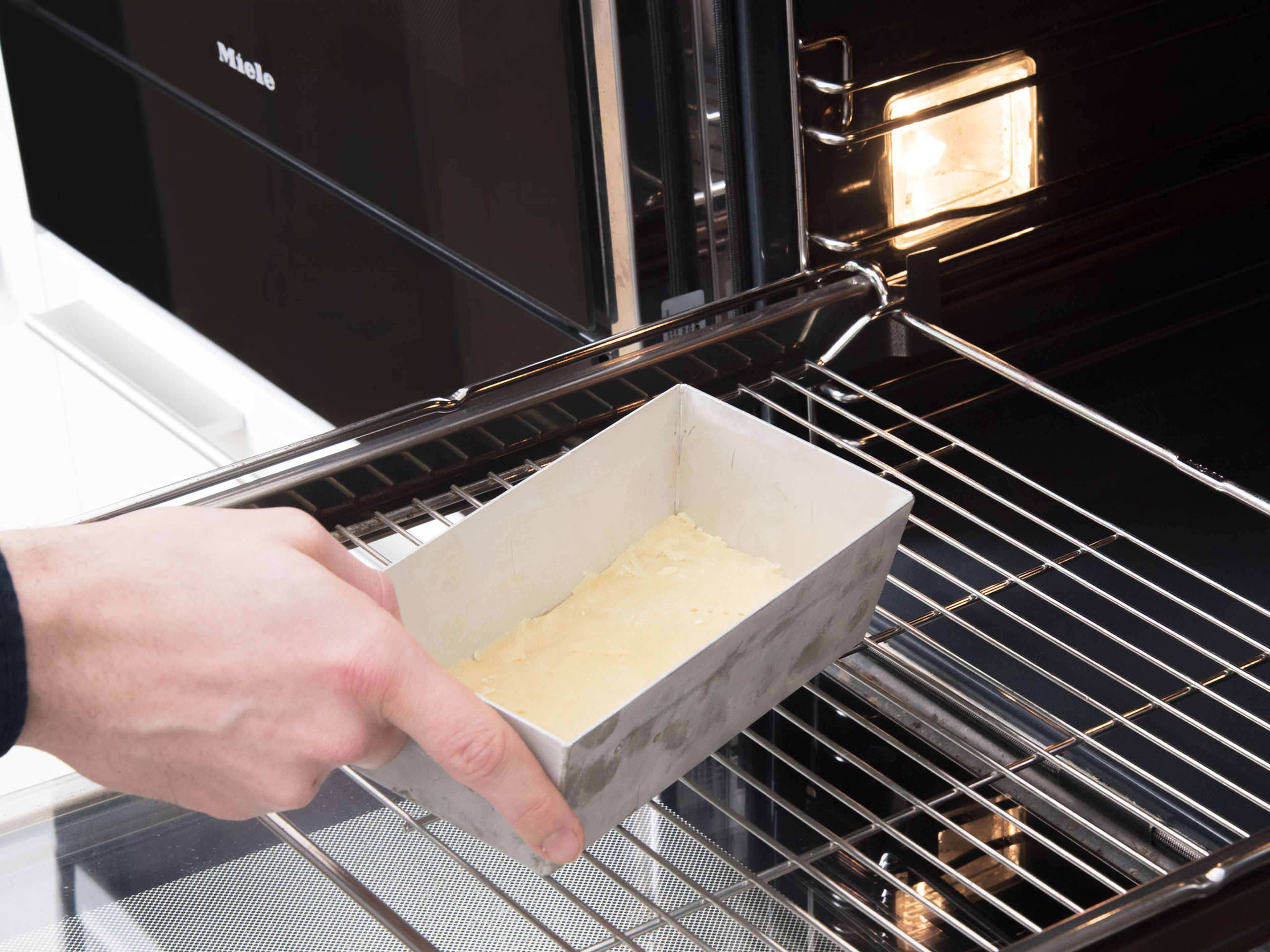 Pre-heat oven to 170°C/340°F. Remove dough from fridge and roll out to a thickness of approx. 5-mm/0.2-in. Transfer dough to the bottom of a parchment-lined loaf pan and trim off any excess. Bake for approx. 15 min.