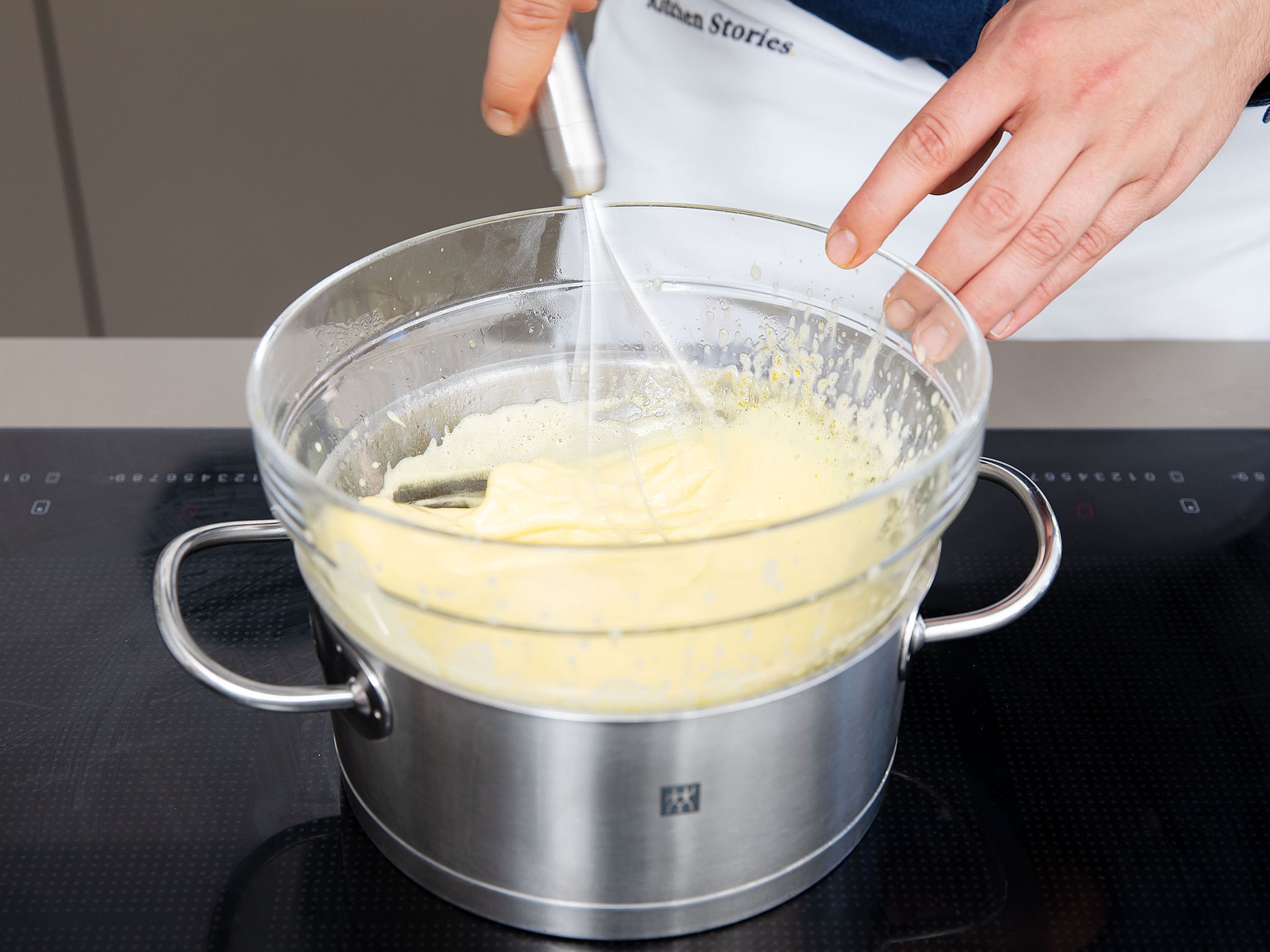 Set up a double boiler and beat the egg yolks and white sugar over a water bath until creamy.