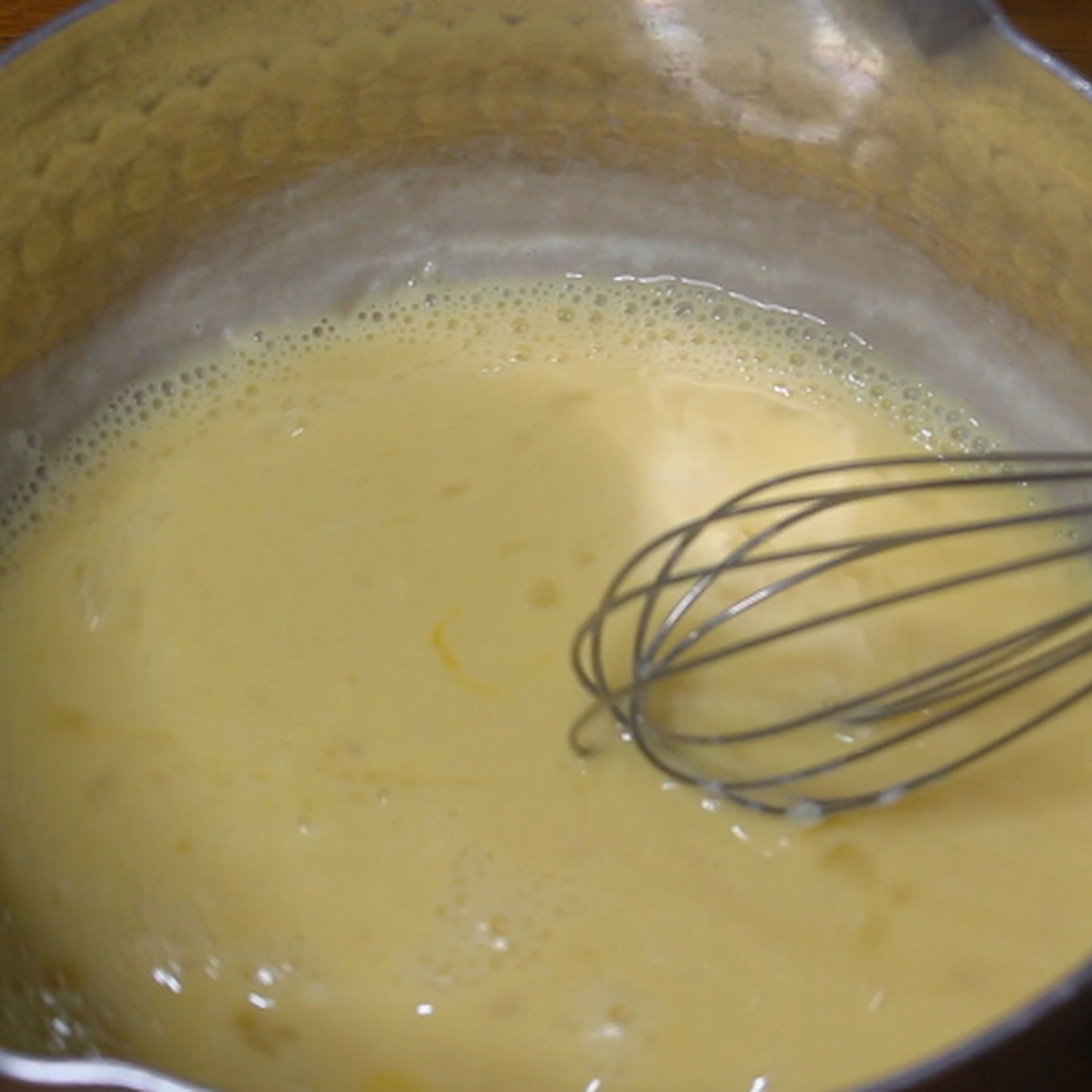 Combined the warm milk with brown sugar, salt in a large bowl and whisk it well until the sugar melted. And add the whole egg and whisk it well.