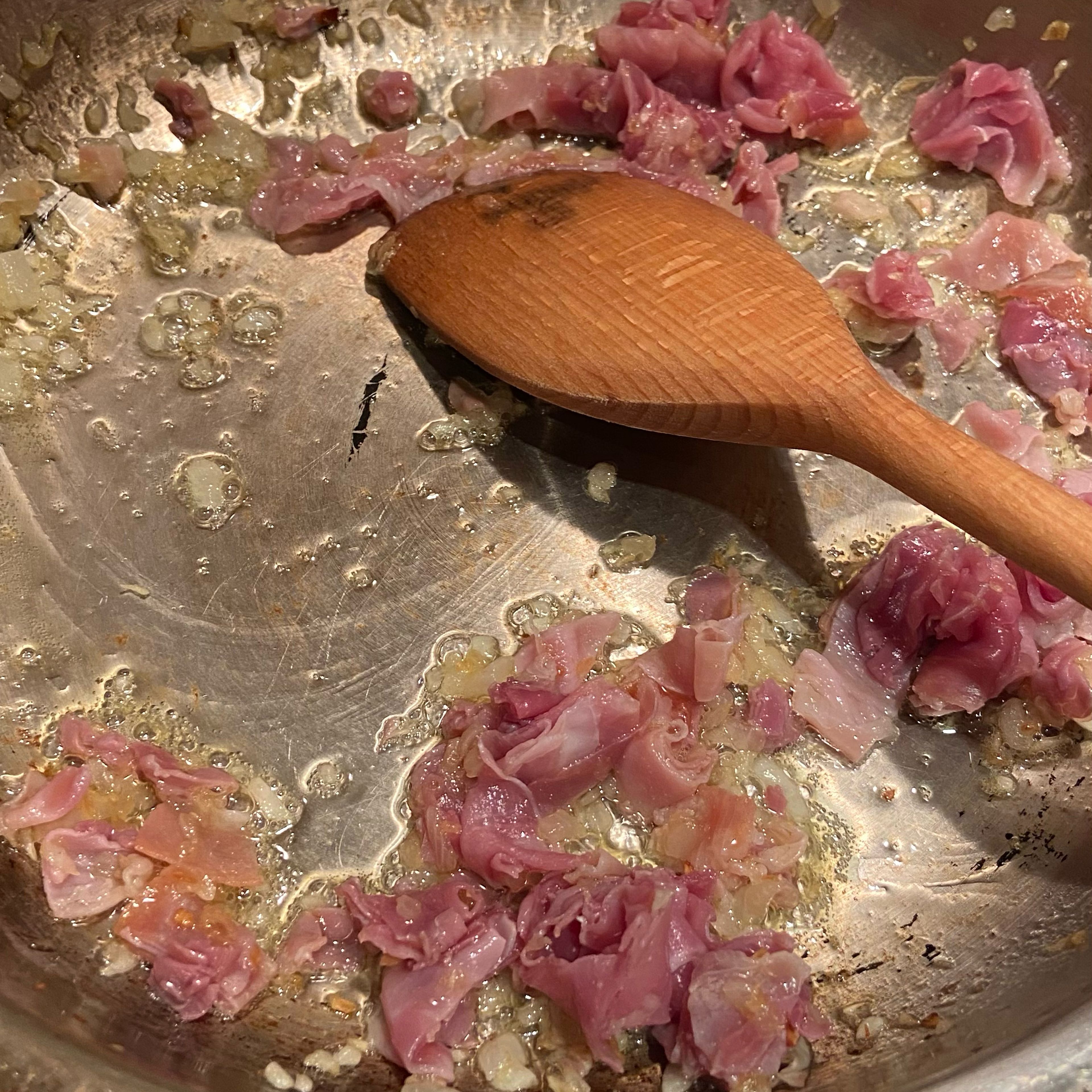 Add the prosciutto and turn the heat down low. And gently move in around the pan. You’re not frying it as such, just letting the fats and salts melt into the butter.