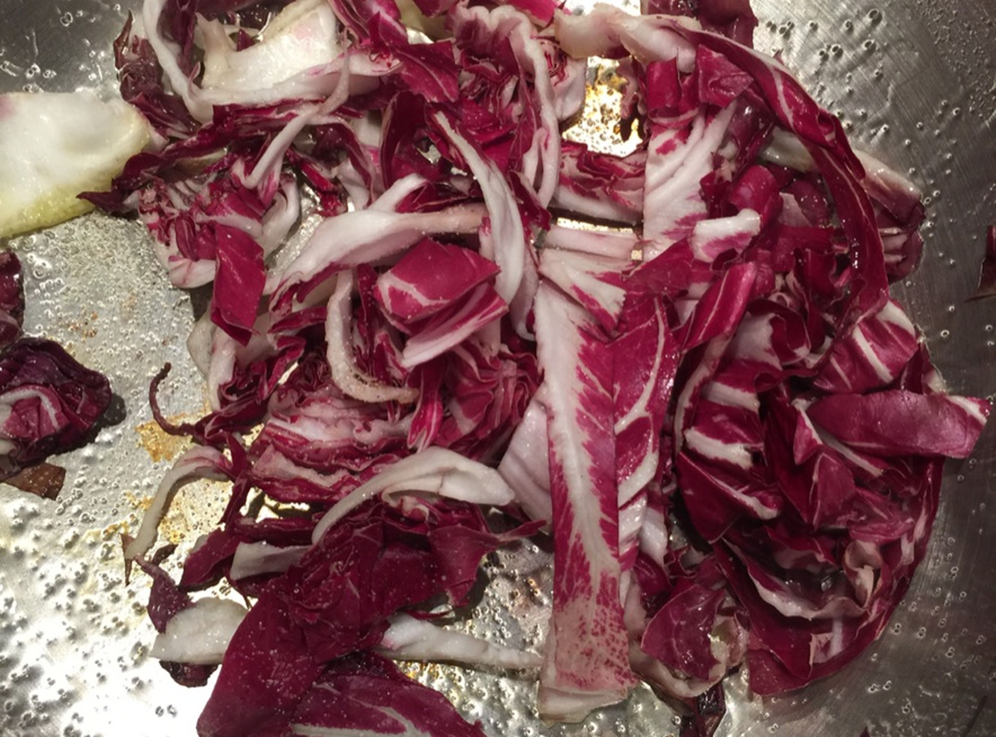 Roughly chop radicchio. Heat vegetable oil in a frying pan over medium heat and fry radicchio until golden brown. Season with salt to taste. Serve hot potato soup in bowls with fried radicchio and freshly chopped chives. Enjoy!