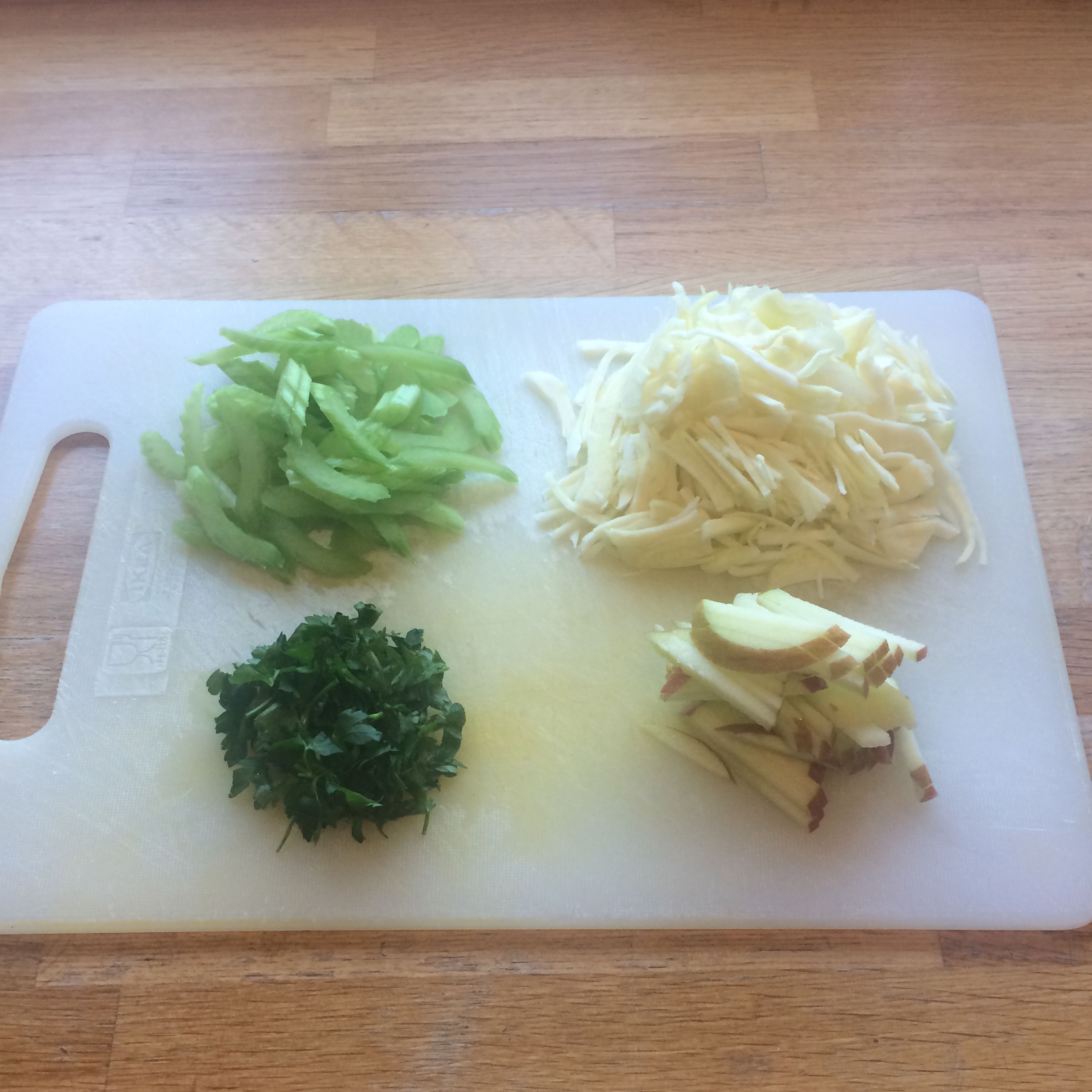 Prepare waldorf slaw by finely chopping cabbage, celery and matchstick the apple