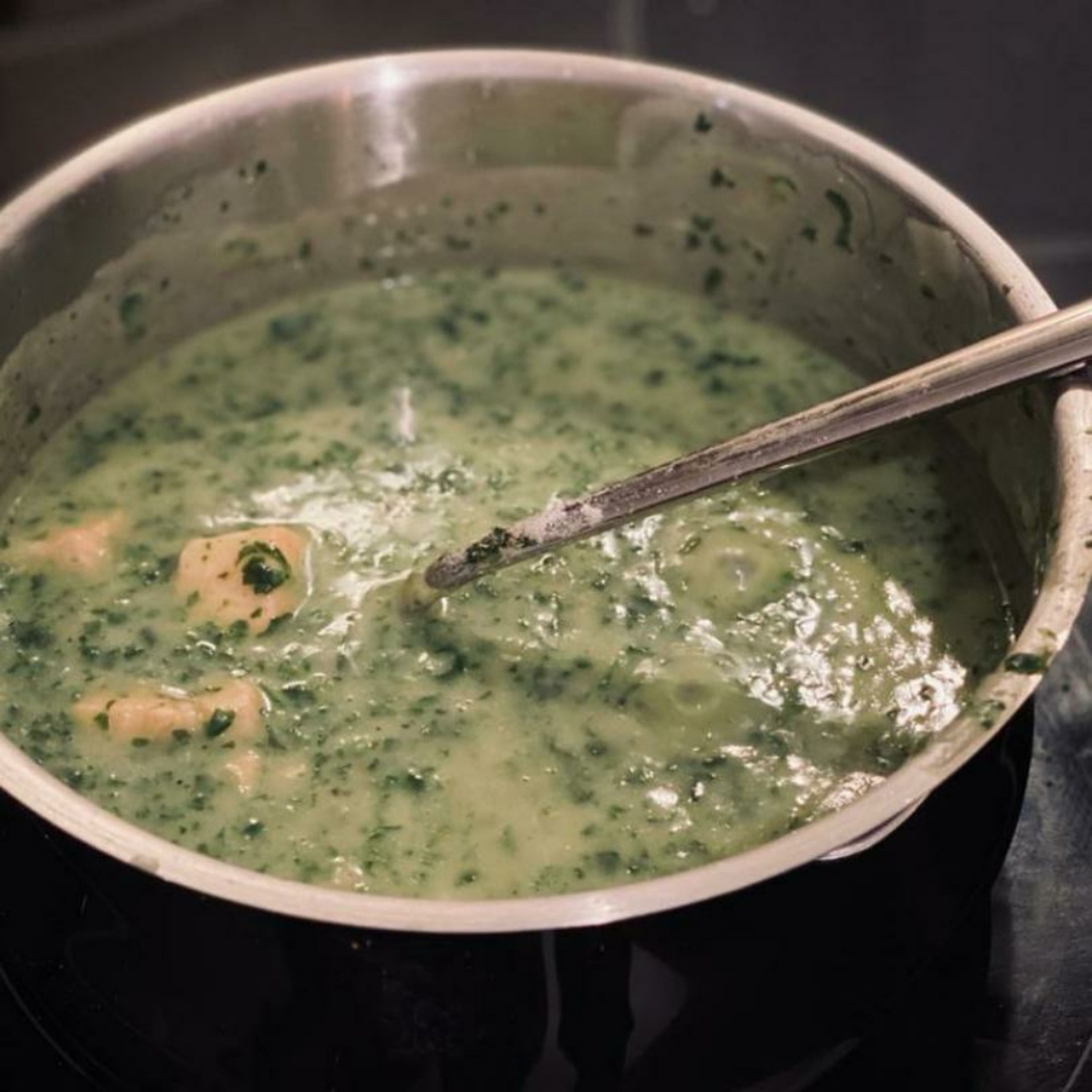 Spinat und Lachs zu der Soße in den Topf geben, ca. 7 Min. köcheln lassen. Geriebenen Parmesan hinzugeben, mit Muskat, Salz und Pfeffer würzen.