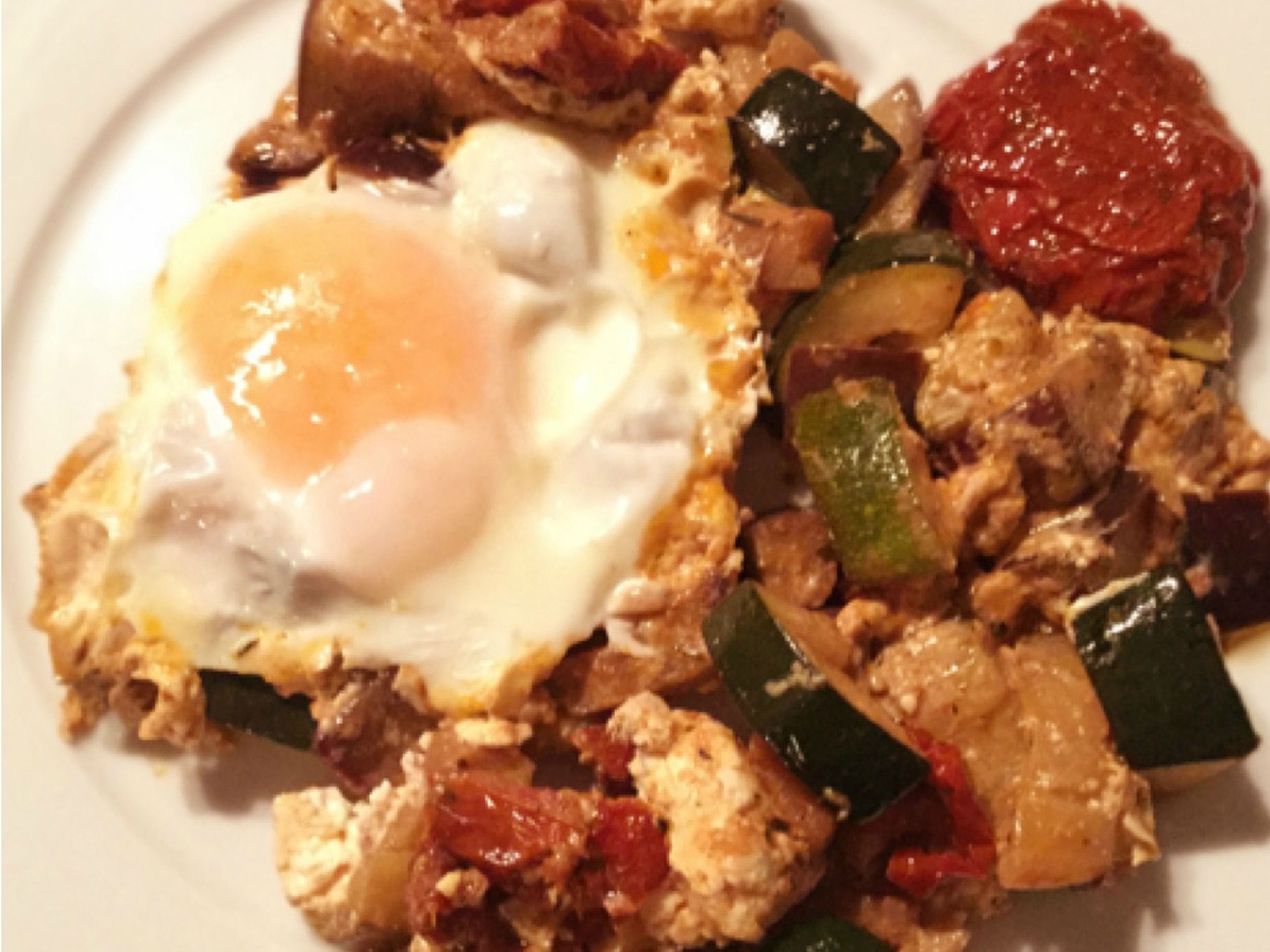 Greek-style fried vegetables with feta and egg