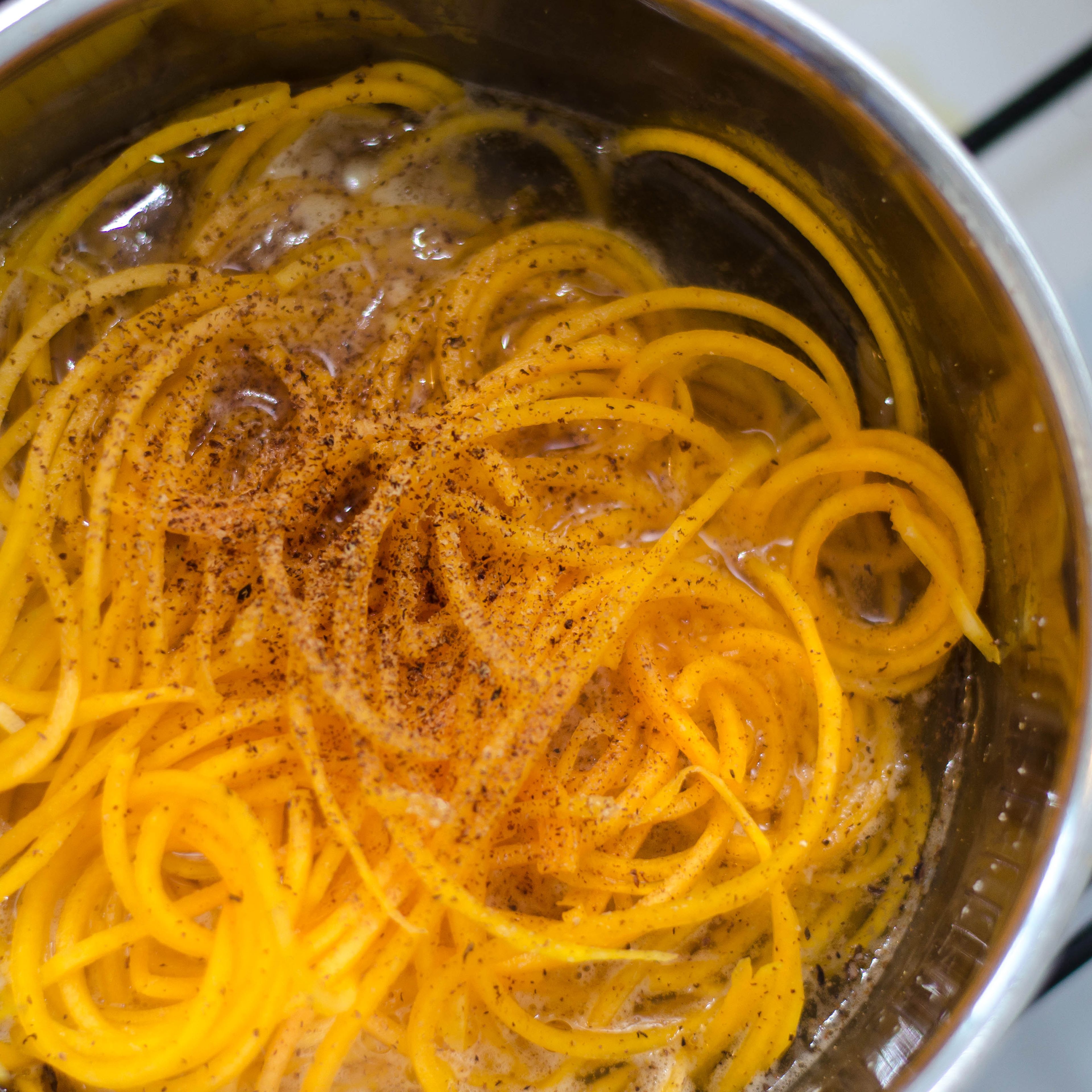 Bring a pot with water to a boil, add salt, and blanch butternut spaghetti for approx. 5 min. Meanwhile mix olive oil, soy sauce, agave syrup, and peanut butter in a bowl. Add minced garlic, sliced chili, salt, and pepper and whisk to combine. Add quinoa, butternut spaghetti, and leek to a serving bowl. Add the peanut-soy dressing and toss to combine. Serve immediately and enjoy!