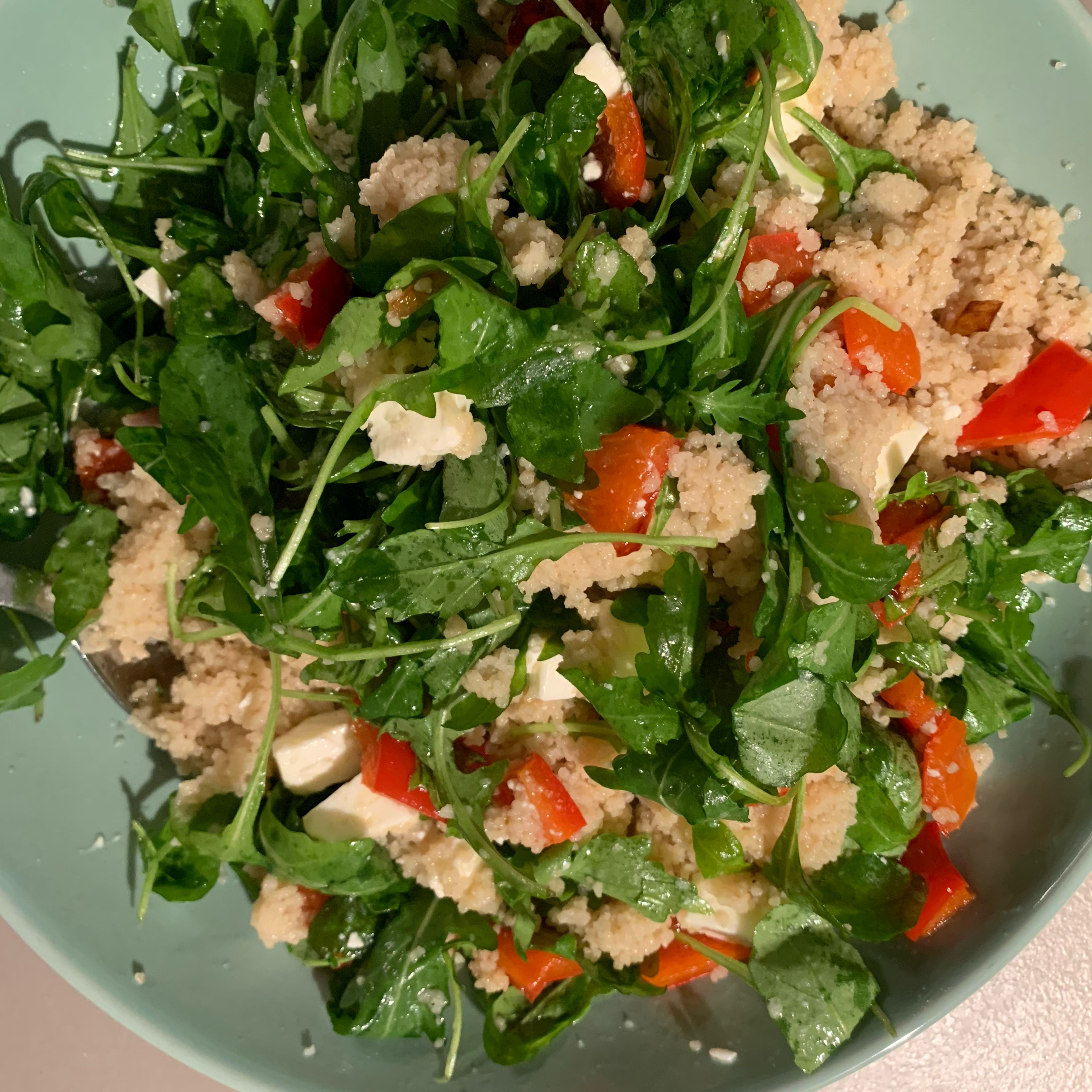 Mix the couscous, arugula, feta cheese, pepper, chopped parsley, olive oil and salt in a bowl.