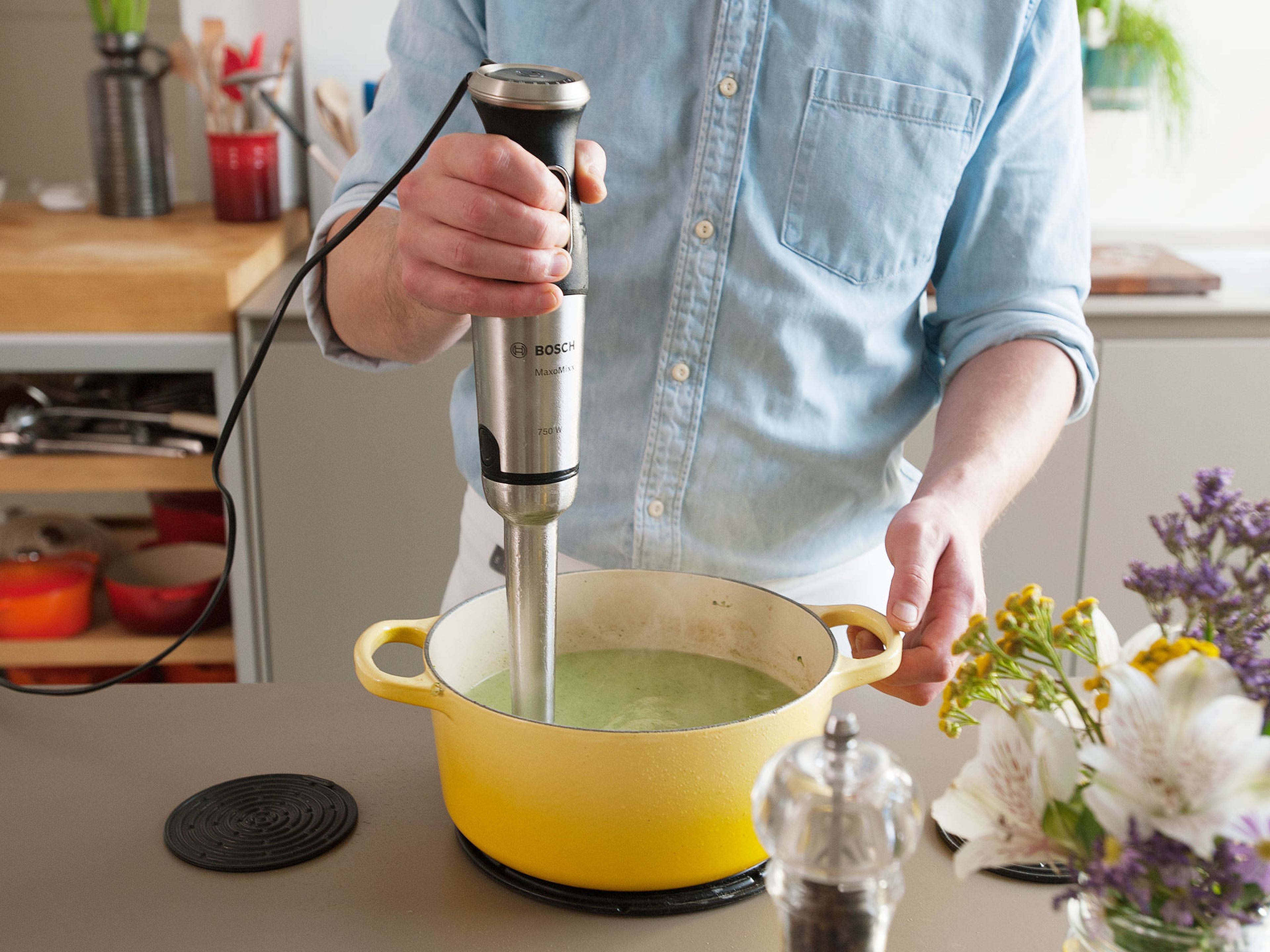 Add broccoli florets to the saucepan and continue to simmer for approx. 5 – 7 min., until soft. Remove pot from heat. Use a hand blender to purée until smooth.  Afterwards add crème fraîche. Add lemon zest and lemon juice to taste. Season with salt and pepper and blend again to combine.