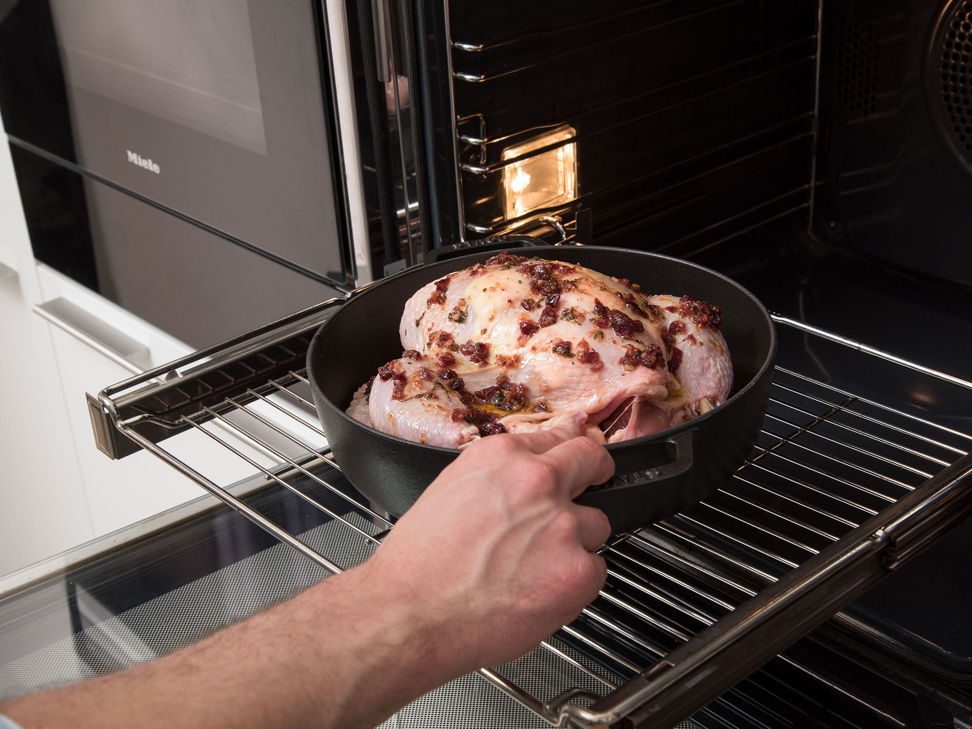 Spread some butter underneath the chicken skin, between the breast and the skin. Transfer chicken to the roasting pan and brush blood orange sauce over it with a pastry brush. Bake at 180°C/350°F for approx. 60 min., basting with blood orange sauce approx. every 20 min.