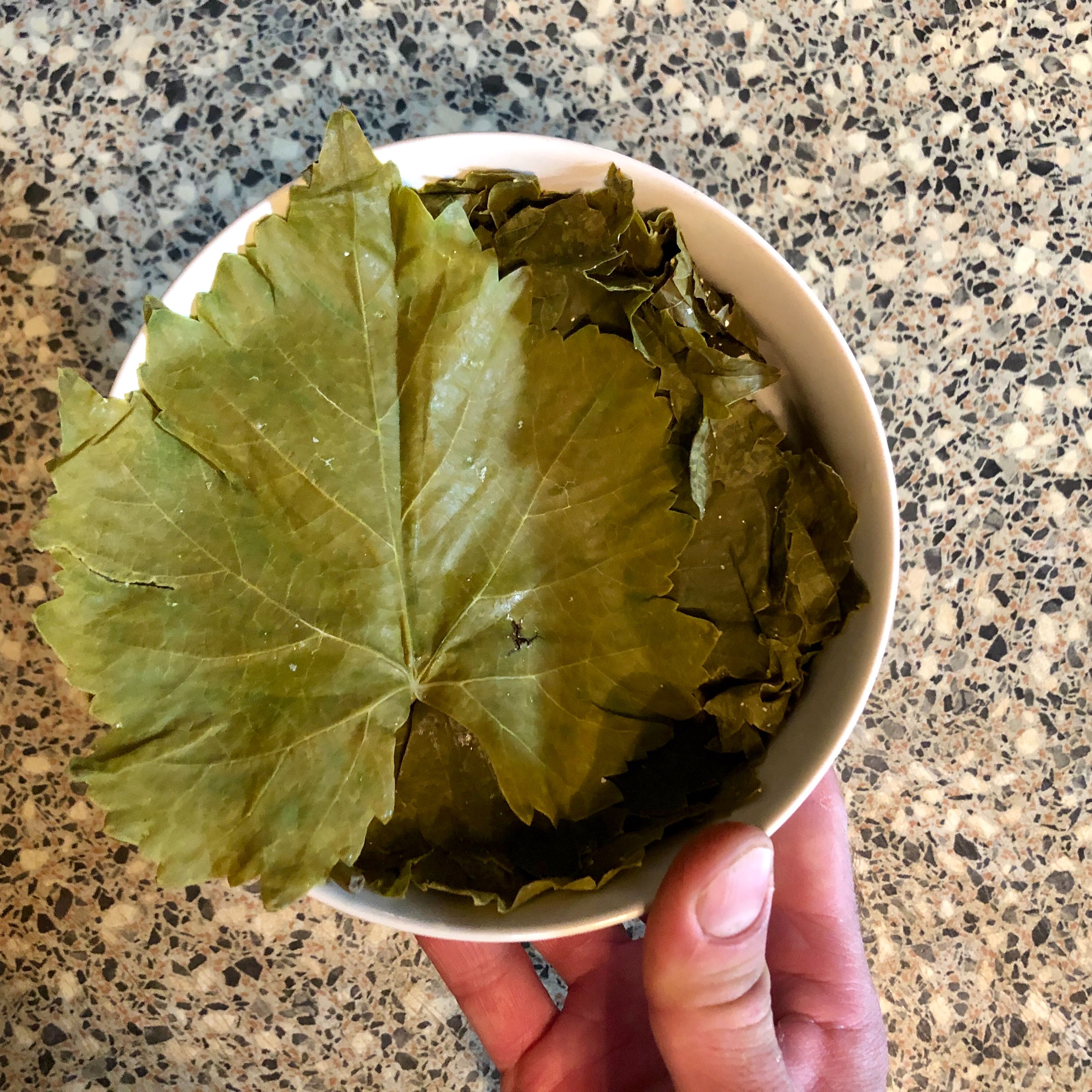 If using fresh grape leaves, cut off the stems and blanch them in boiling water first. But if you are using canned leaves, wash in hot water.