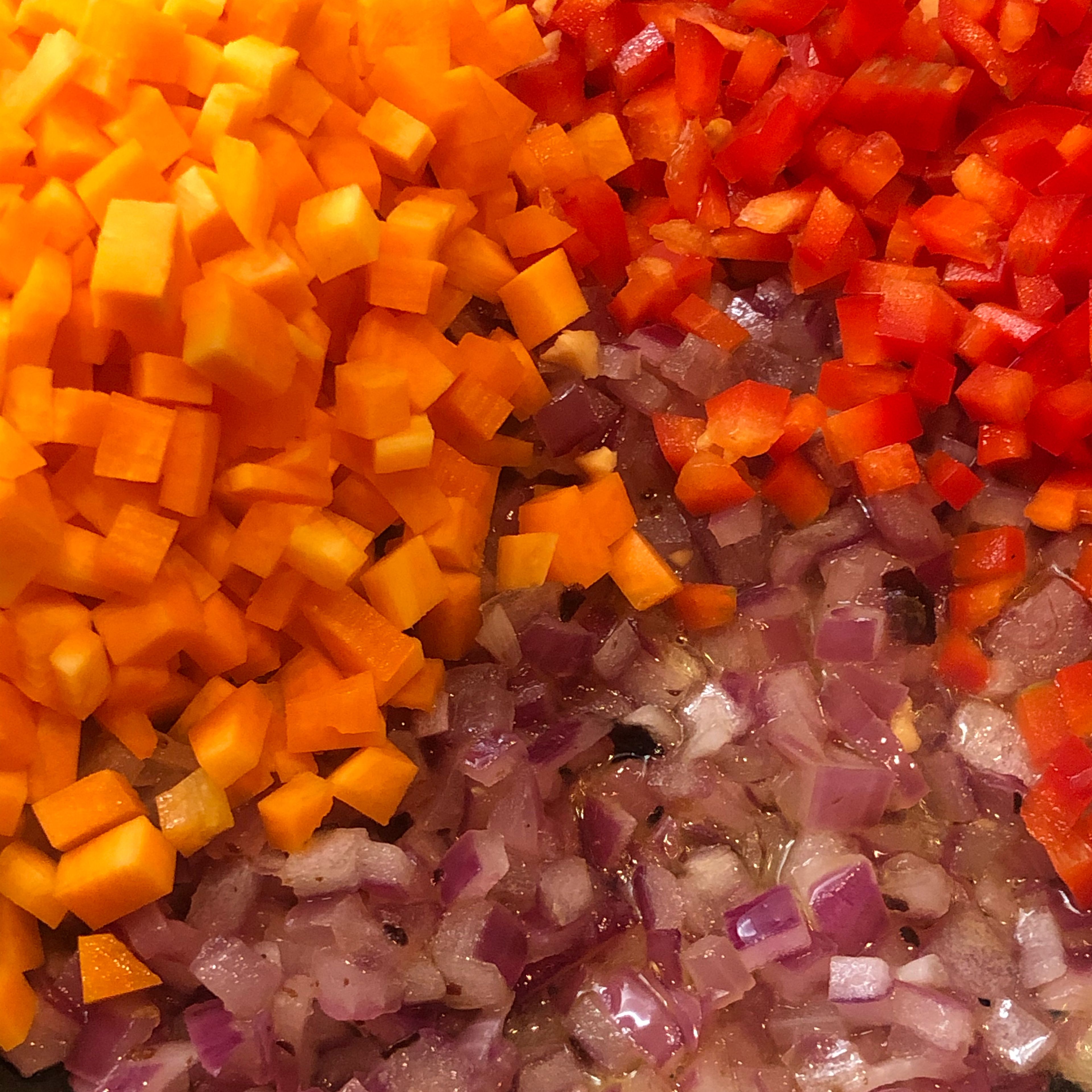 While the quinoa is cooking, you can brunoise the red onion, the carrot and the red bell pepper. Heat olive oil in a wok or a pan and sauté the vegetables. Reserve until the quinoa is ready. You can get creative by adding some spices like curry, thyme, pepper -of course- or whatever you like.