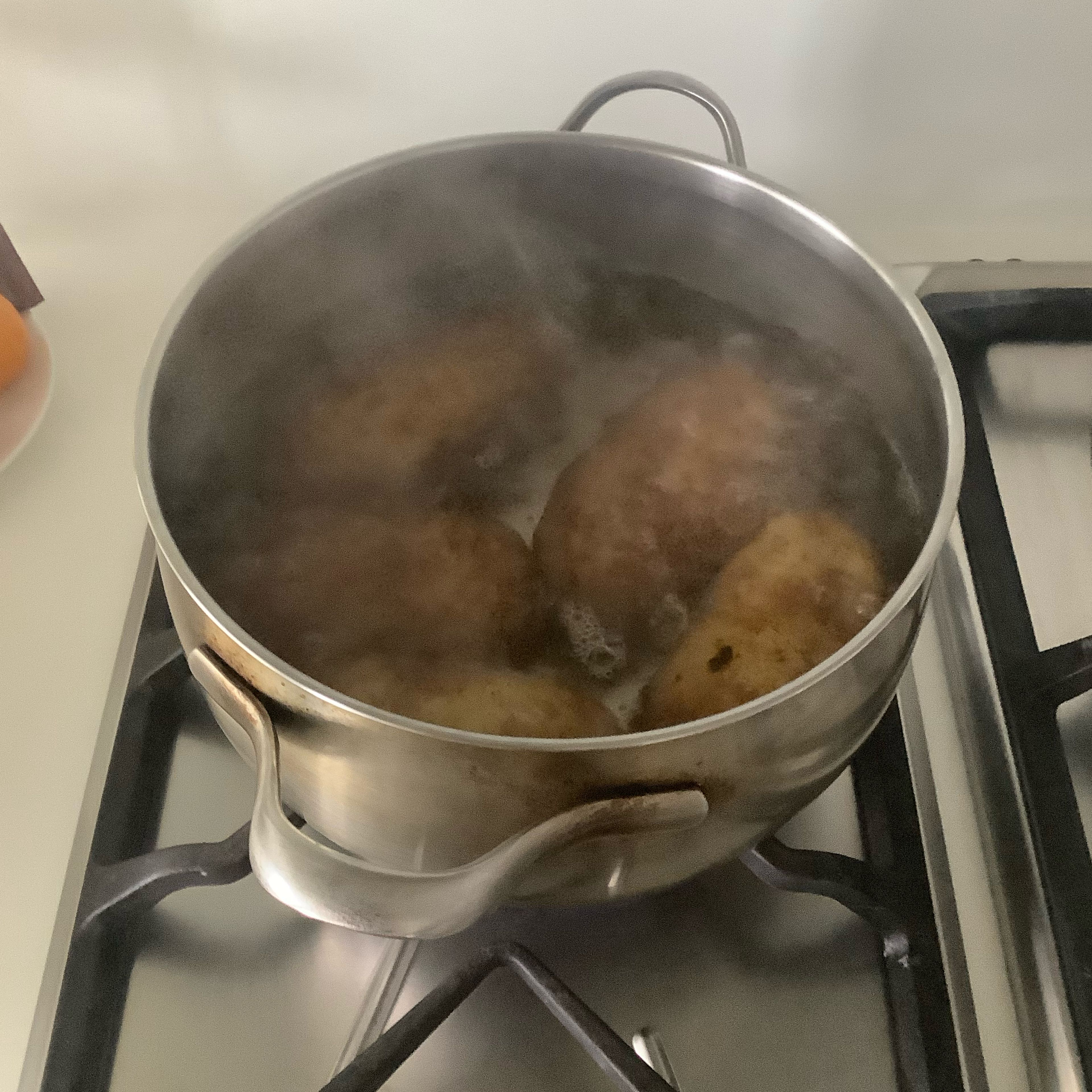 Rinse your potatoes, and then place them in boiling water for around 40 minutes