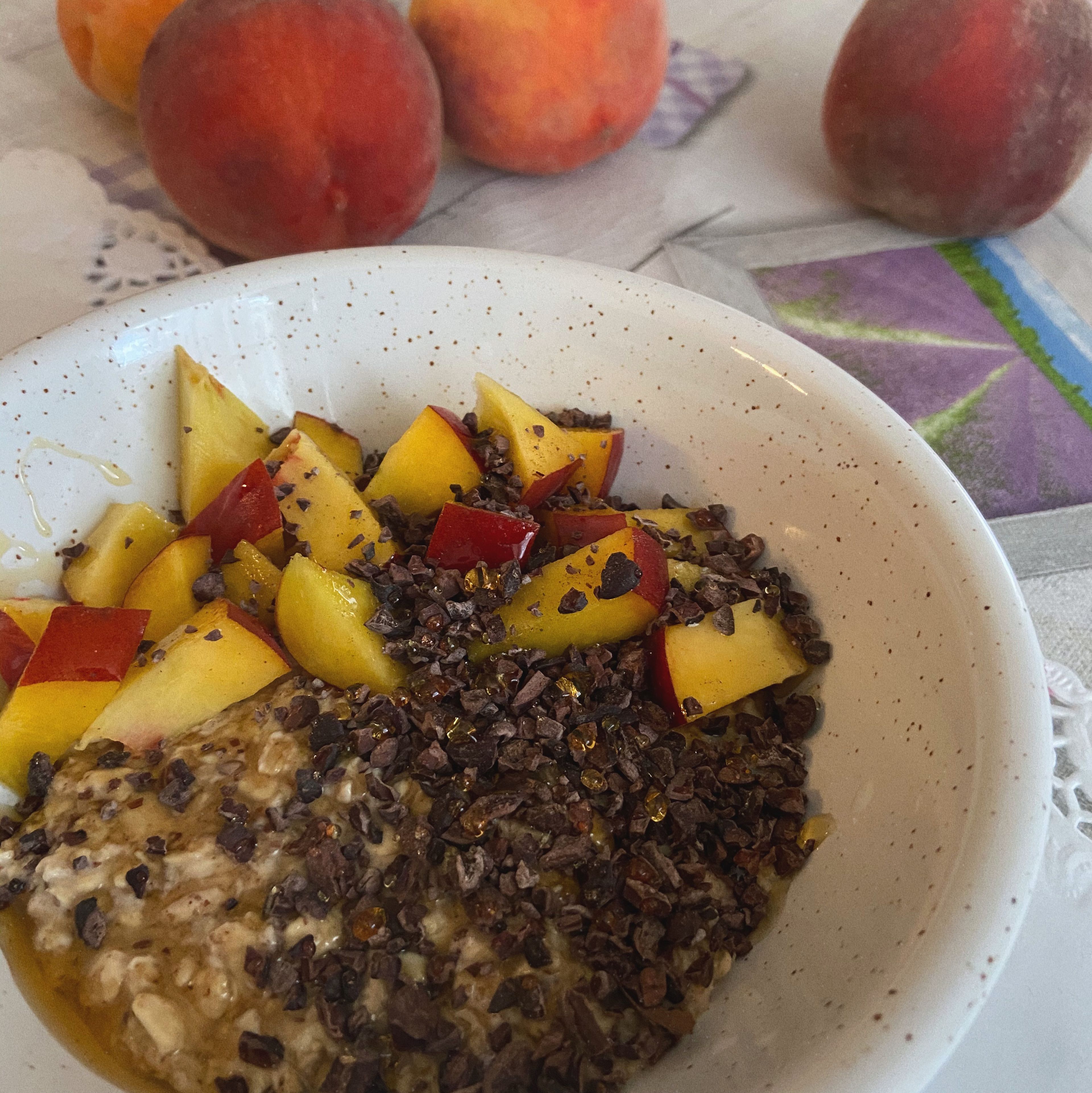In the morning add the toppings: peach, cacao nibs and honey.