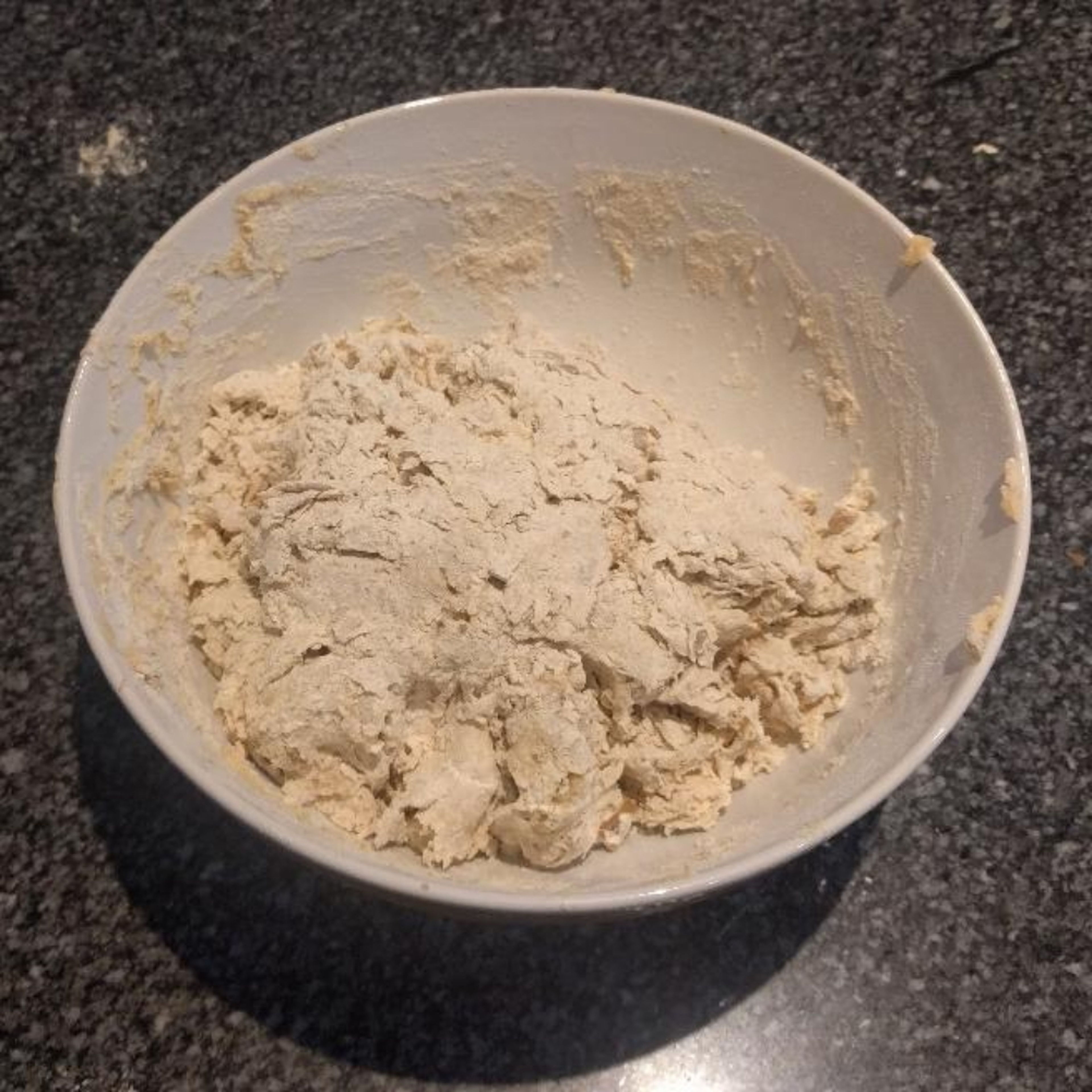 Keep mixing water, if you overwater, add a bit of white flour into the mix and try moulding it again. Either way, you'll have to get messy.