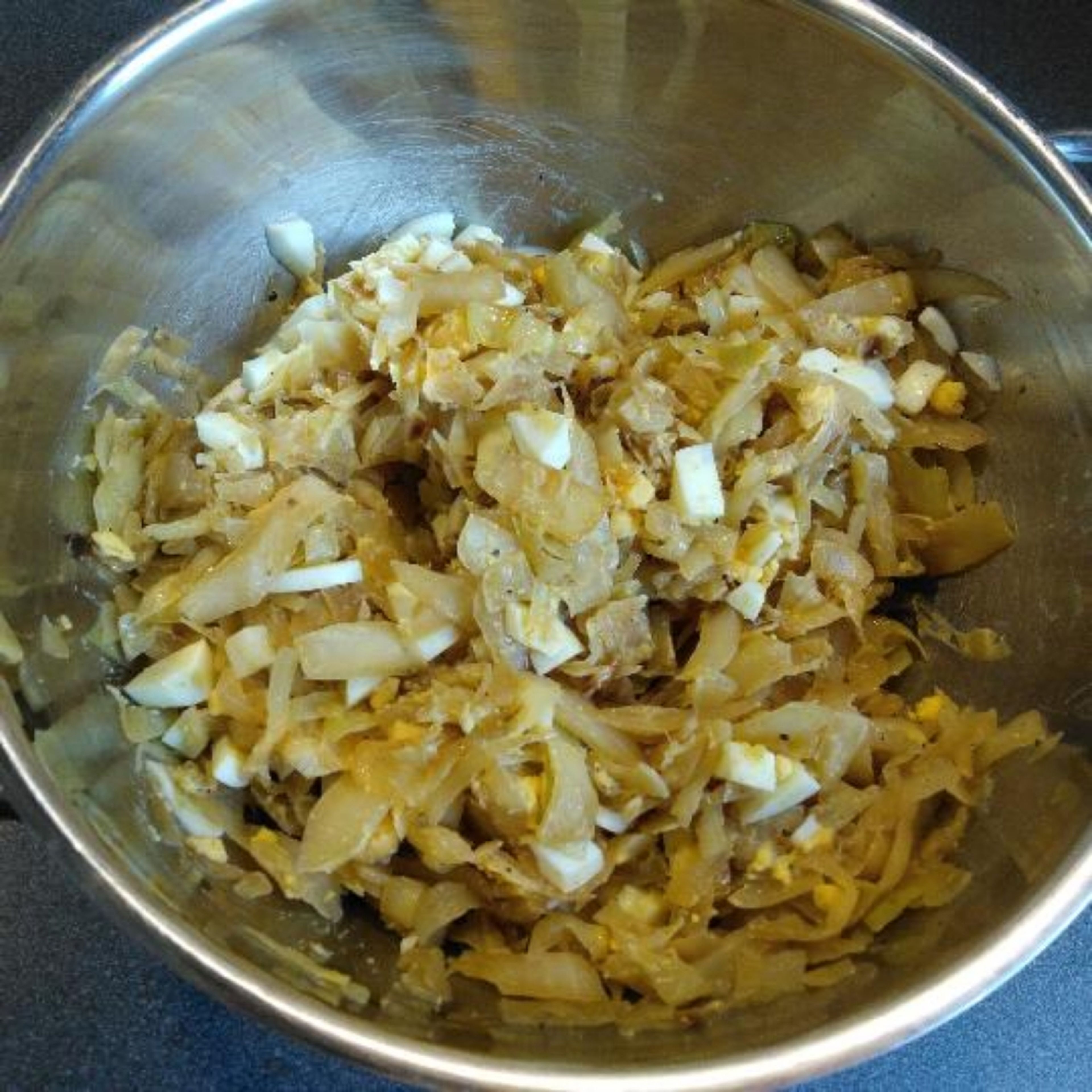 In a bowl mix cabbage and eggs, and season lightly with salt and pepper. Set aside and let cool.