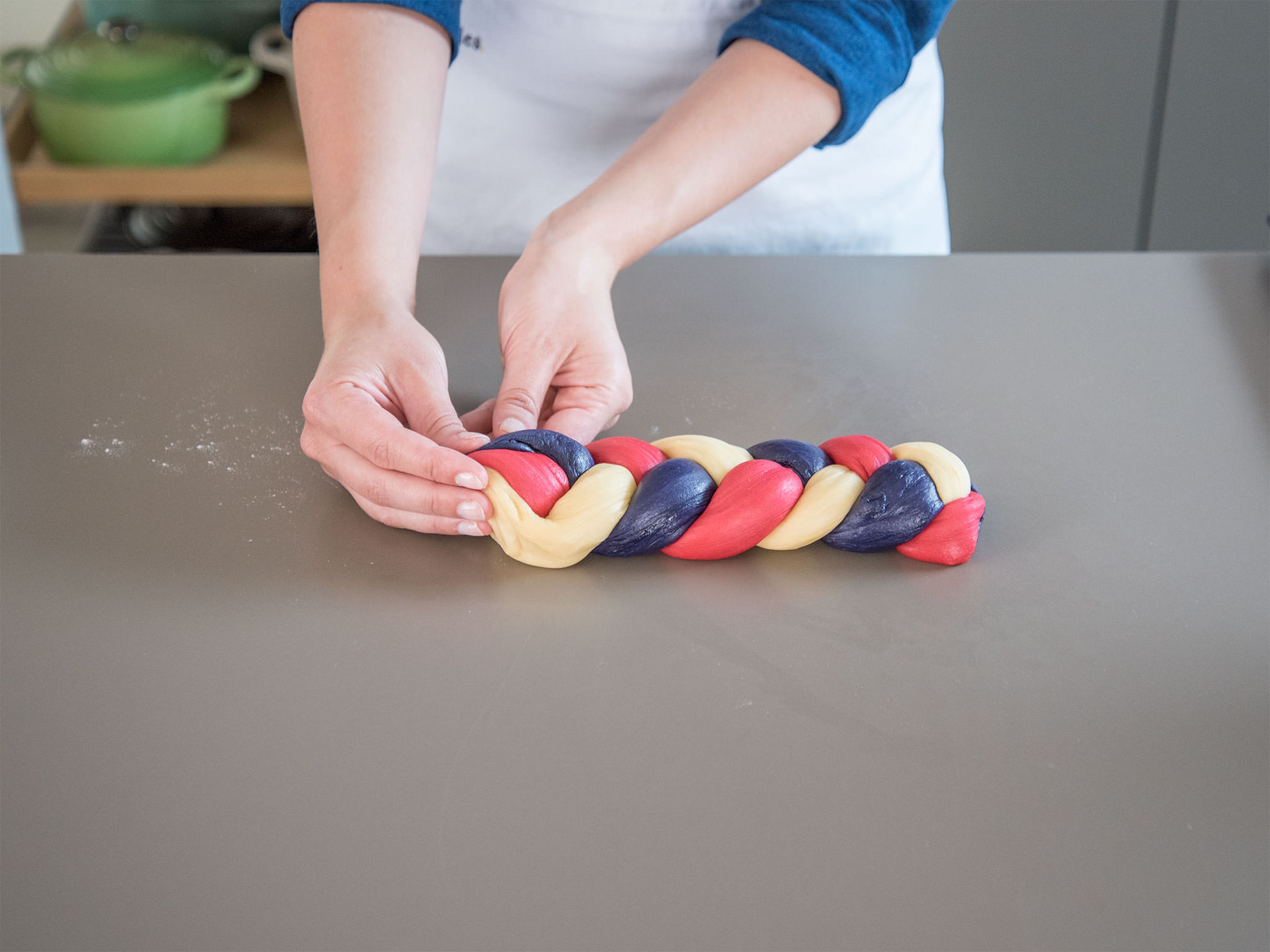 Roll out each piece of dough into 30-cm/12-in. long portions. Braid dough, then lay the loaf across the baking sheet.