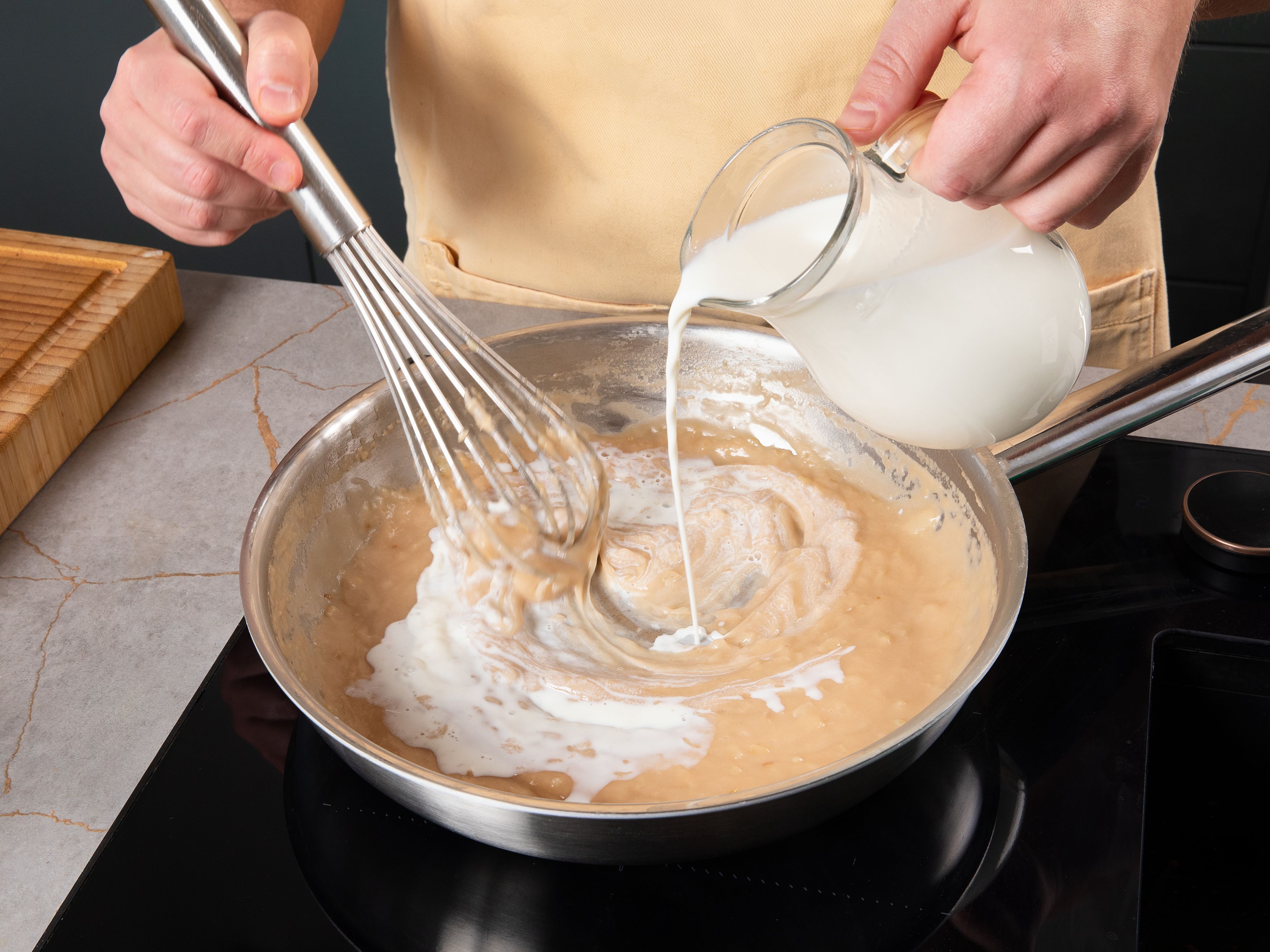 Peel and finely dice onion. Peel potatoes, place in a pot with salted water, bring to a boil, and cook until soft. Meanwhile, heat butter in a pan and sauté onion until translucent. Add flour and stir in. While stirring, gradually add milk and vegetable broth. Bring to a boil and continue stirring until a creamy consistency is achieved.