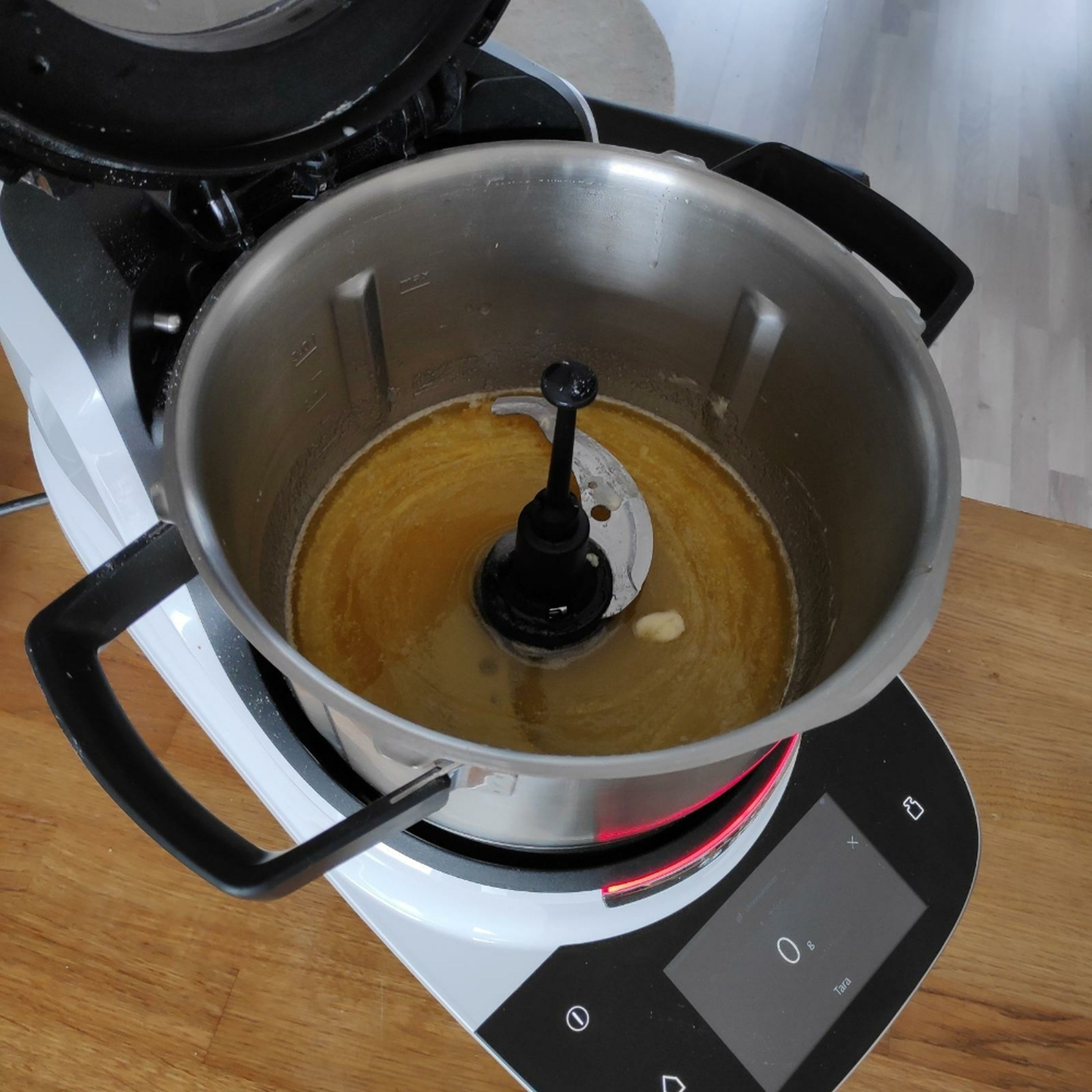 In der Zwischenzeit Universalmesser in den Cookit einsetzen, Zutaten einwiegen und bei geschlossenem Deckel und eingesetztem Messbecher erwärmen (Universalmesser I Stufe 3 I 70°C I 8 Minuten).