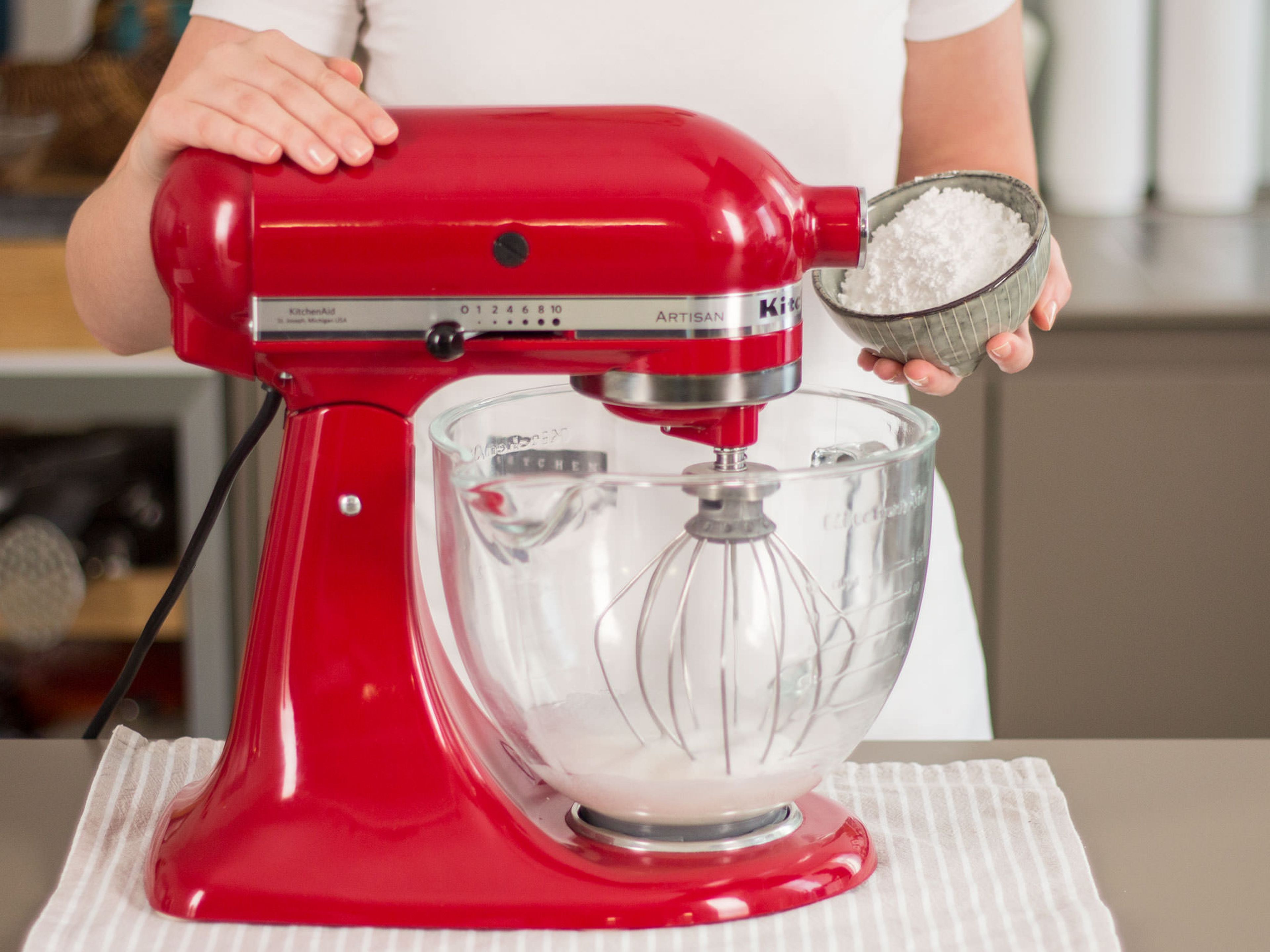 To make the meringue, separate remaining eggs. Add whites as well as remaining confectioner’s sugar to a clean mixer bowl. Beat until stiff peaks form.