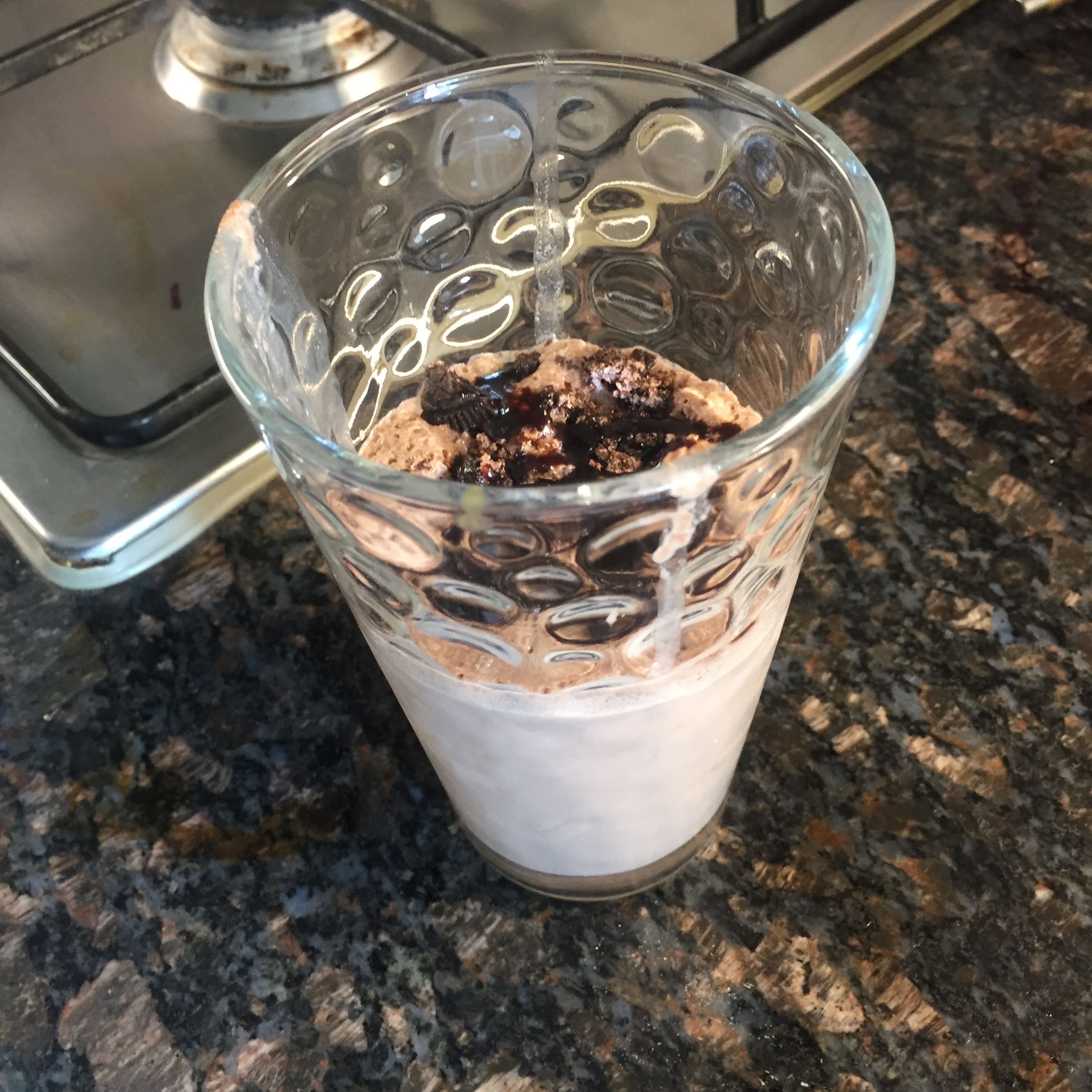 Take a dry blender and add the Oreos and sugar in it. After they become fine powder add the cold milk, vanilla ice cream and blend it for 30 seconds , then add the chocolate sauce and ice cubes and blend it till you observe that the ice cube is crushed. The milkshake is ready. Pour the shake into 2 glasses and top it with crushed Oreos and chocolate sauce.