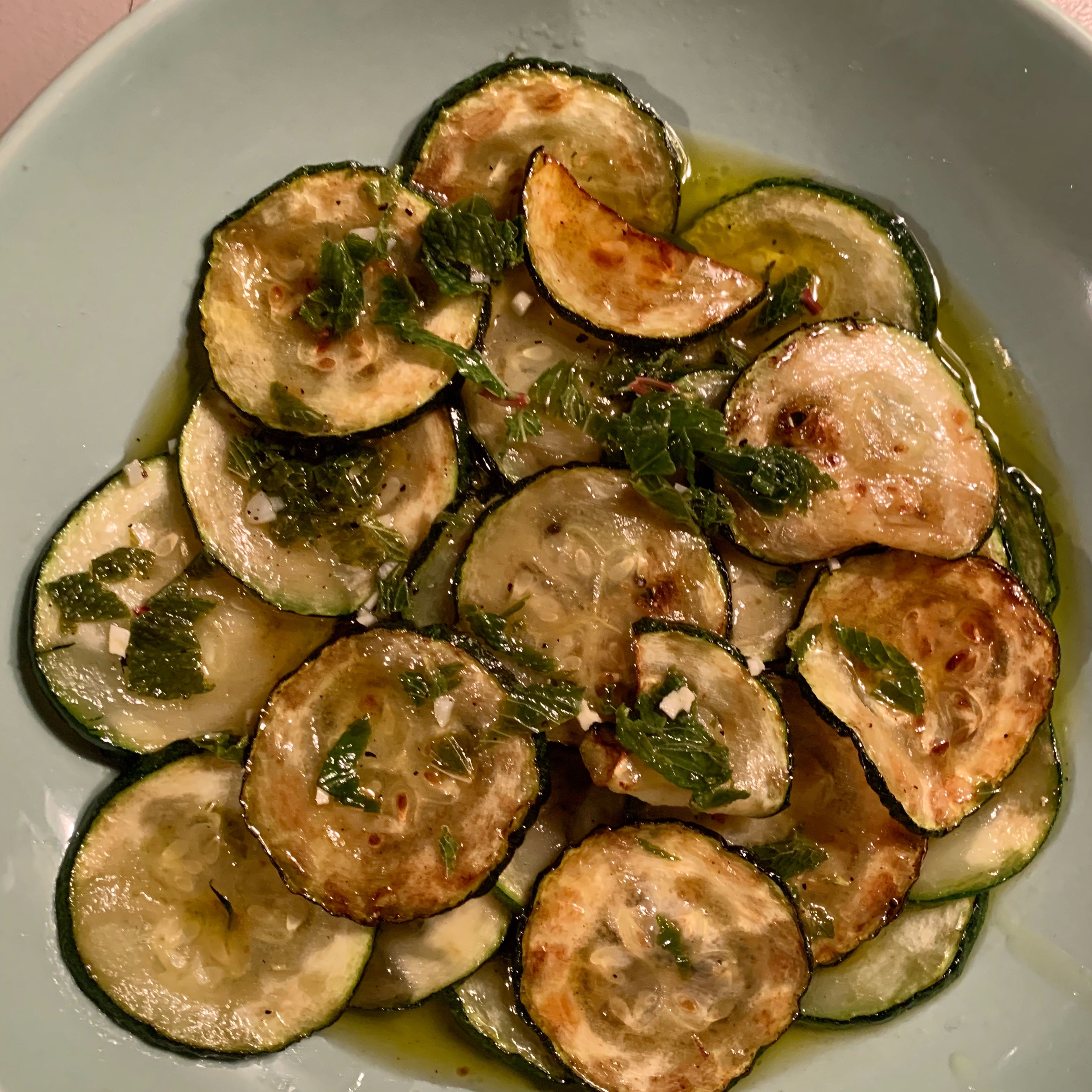 Drain the zucchini and place them over a baking tin or flat plate creating multiple layers. Add the minty dressing between each layer and let it cool down. The dish tastes best when served cold!