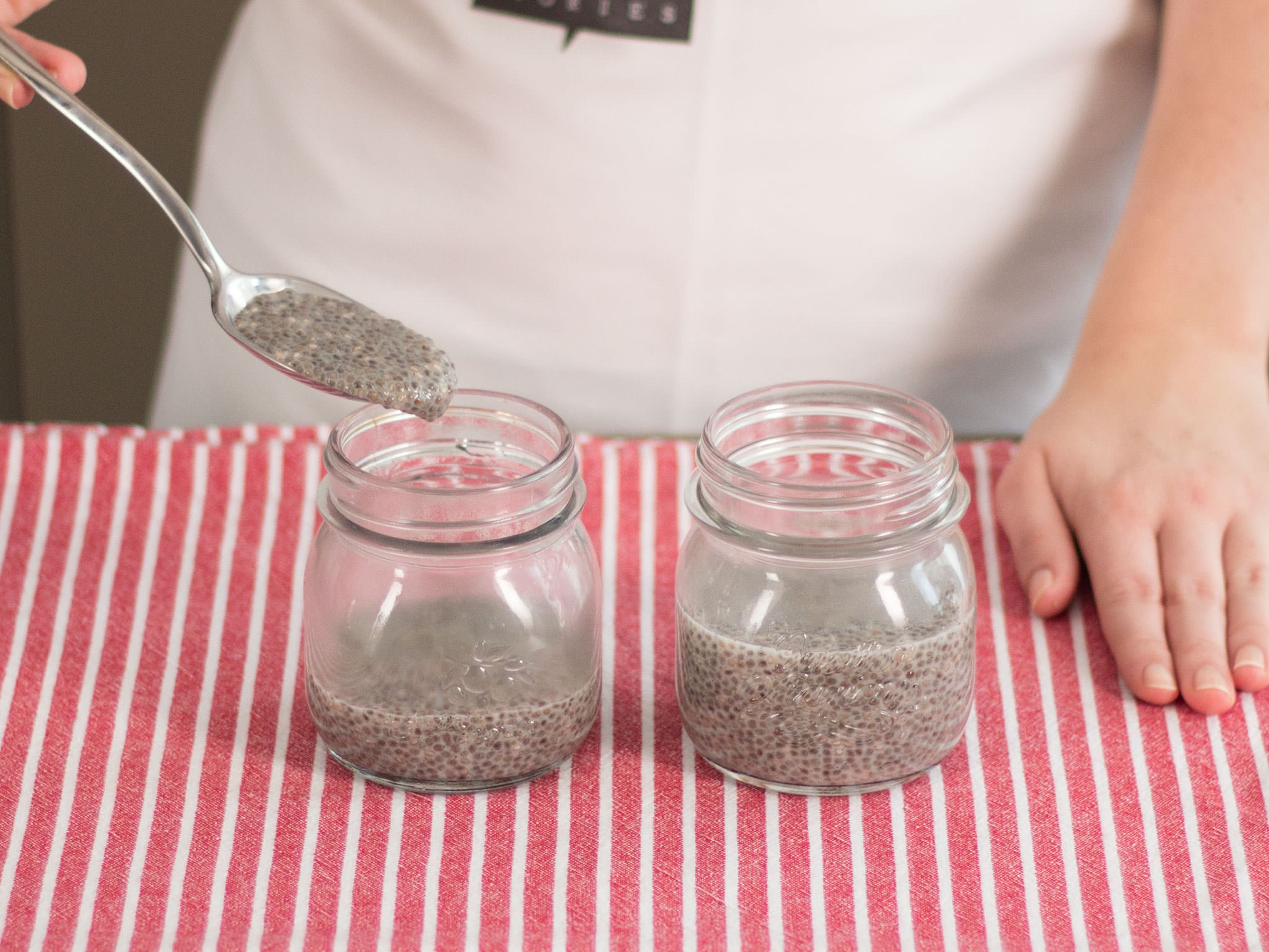 Spoon chia pudding into jars for serving.