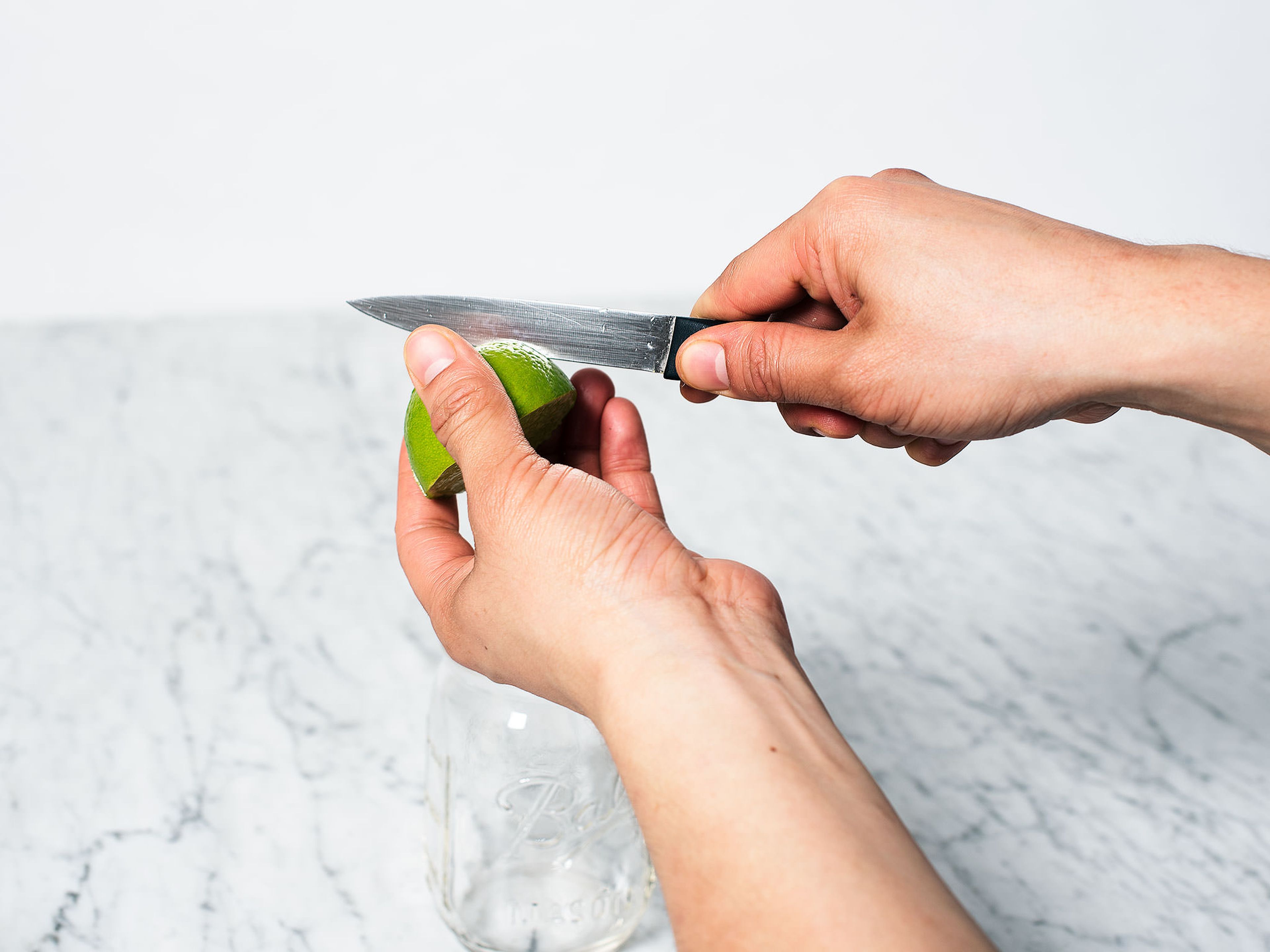 Remove seeds for lime half and score peel 3 times.